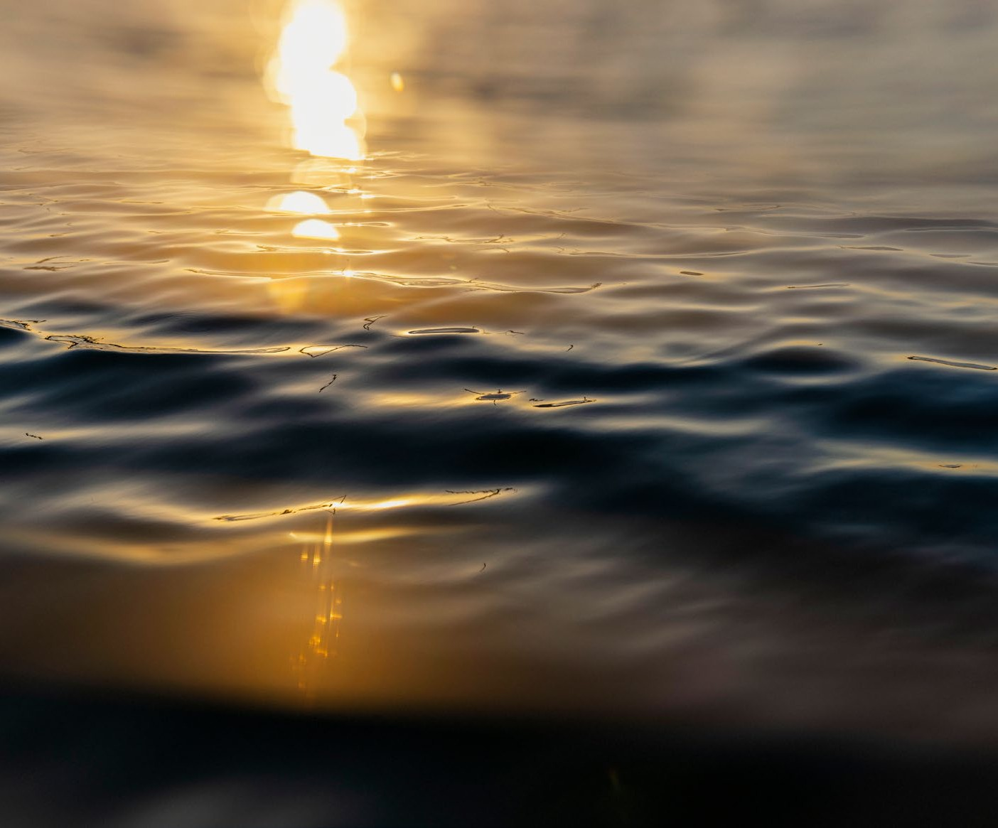 Reflections of the sunset on the rippling water surface