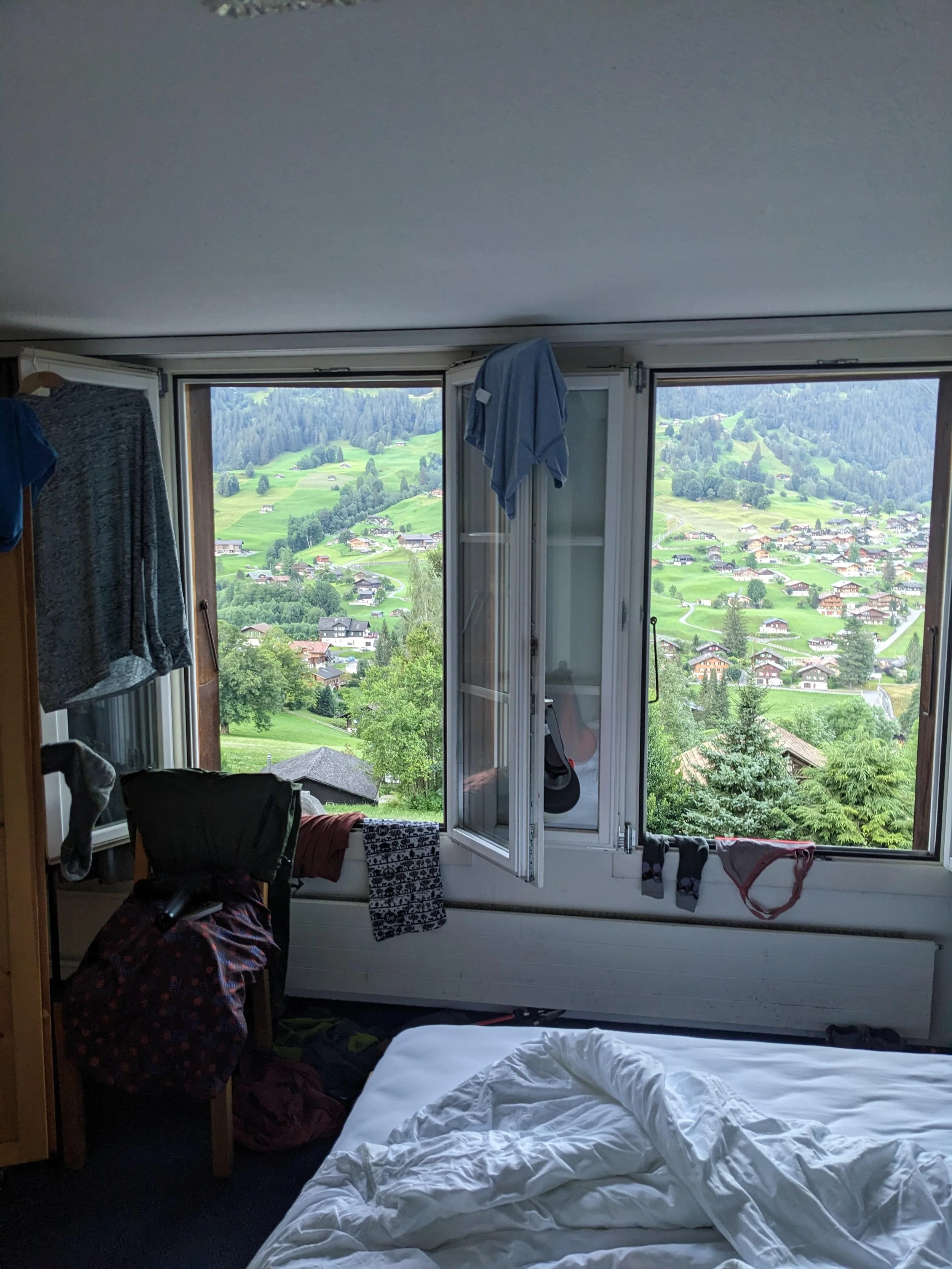 switzerland hotel room, drying nightly hike attire laundry in window