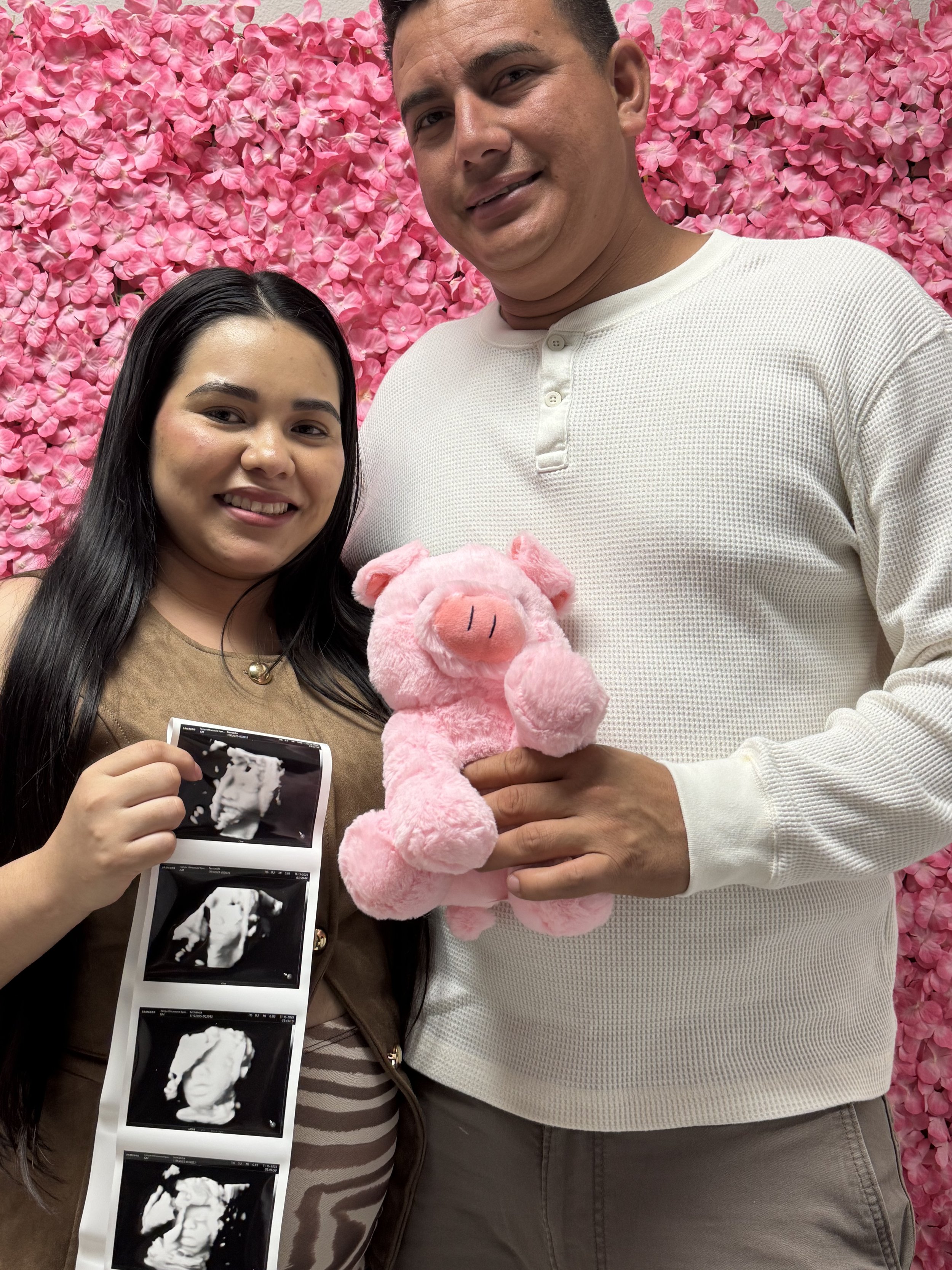 Excited parents showing their 4D ultrasound pictures from Tampa Ultrasound Specialist