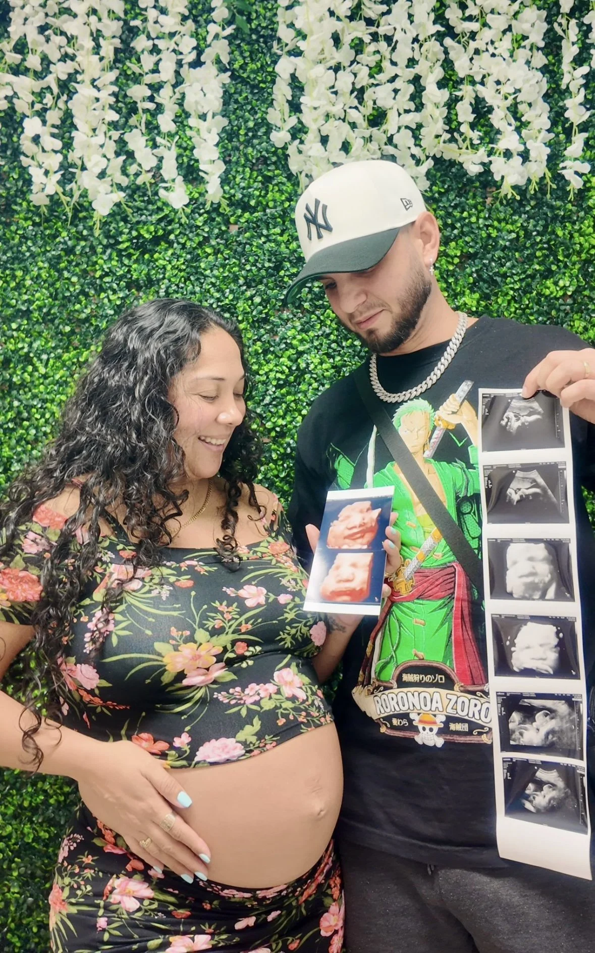 Smiling client holding her 3D ultrasound photos at Tampa Ultrasound Specialist