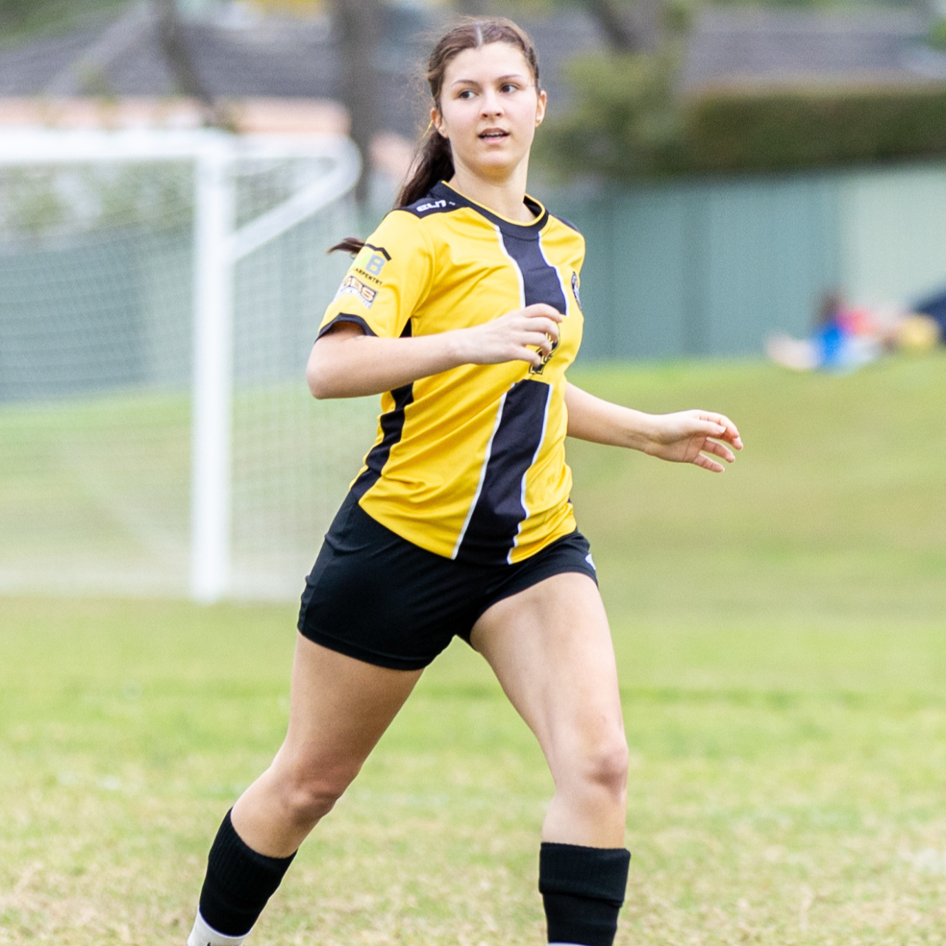 Young woman in a Pendle Hill FC soccer jersey playing in Toongabbier for the Phoenix Womens League.