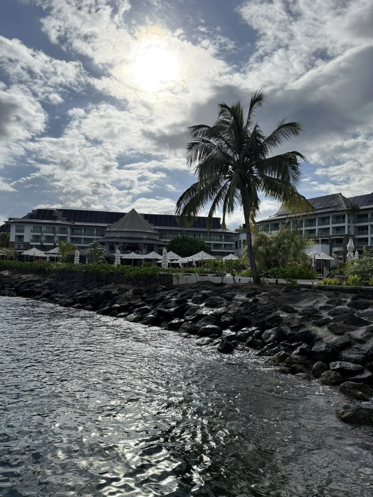 Luxury hotel in Tahiti viewed from the water for a French Polynesia island escape