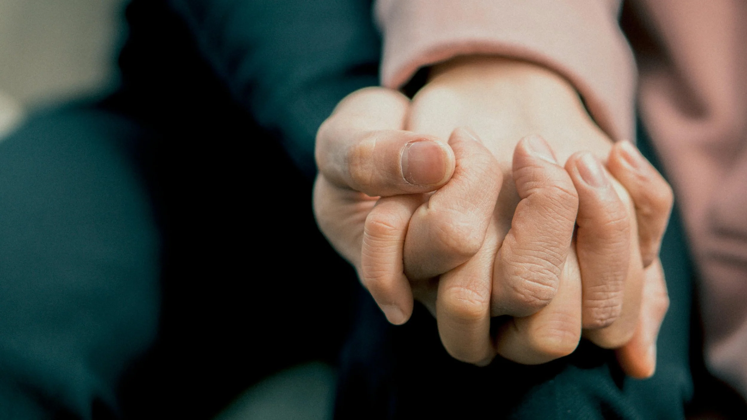 Support and connection. Close-up of two hands grasping each other.