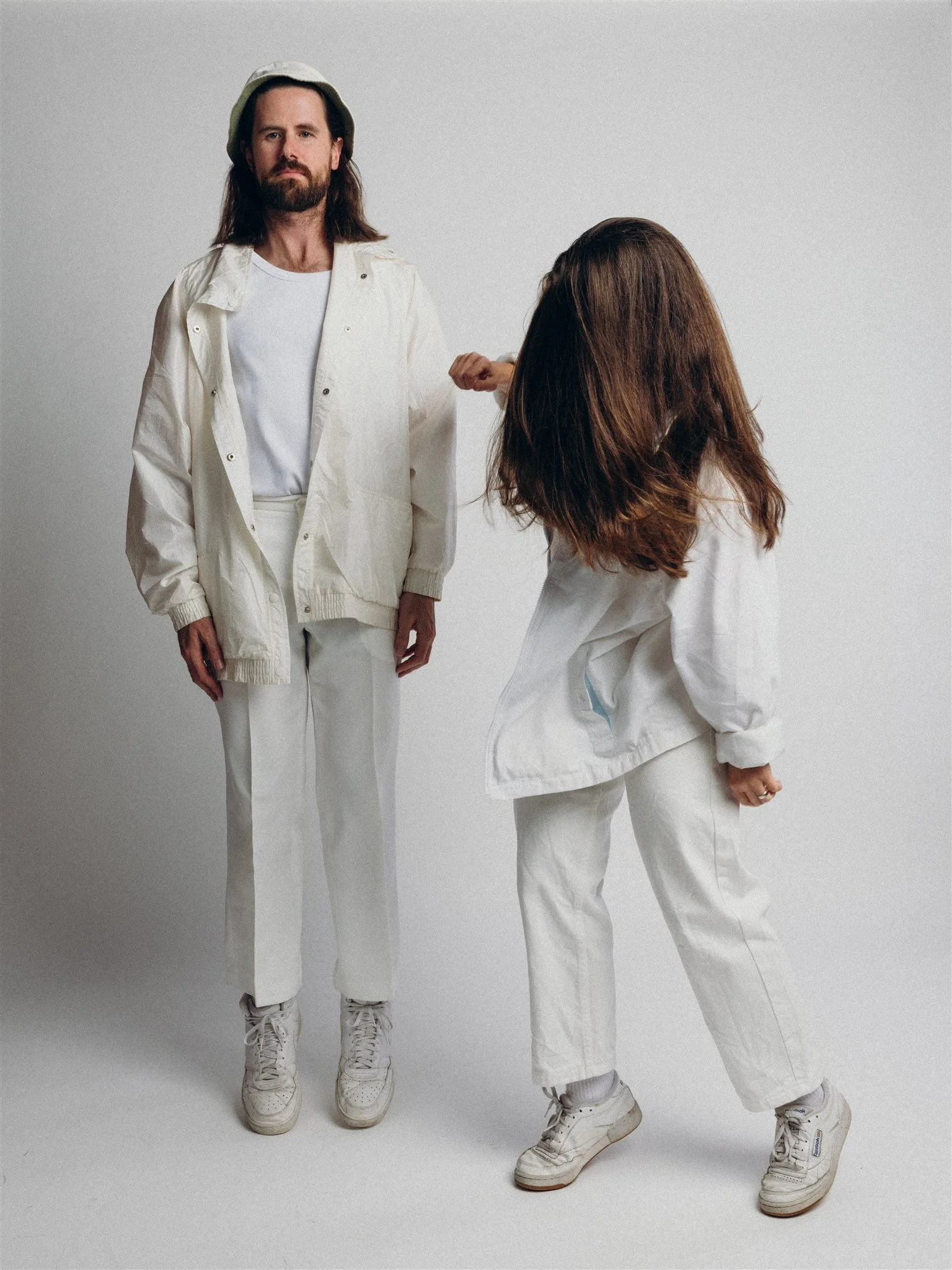 Kate and Dayle from the band Love Party, dressed in white and dancing. Photo by Nick George