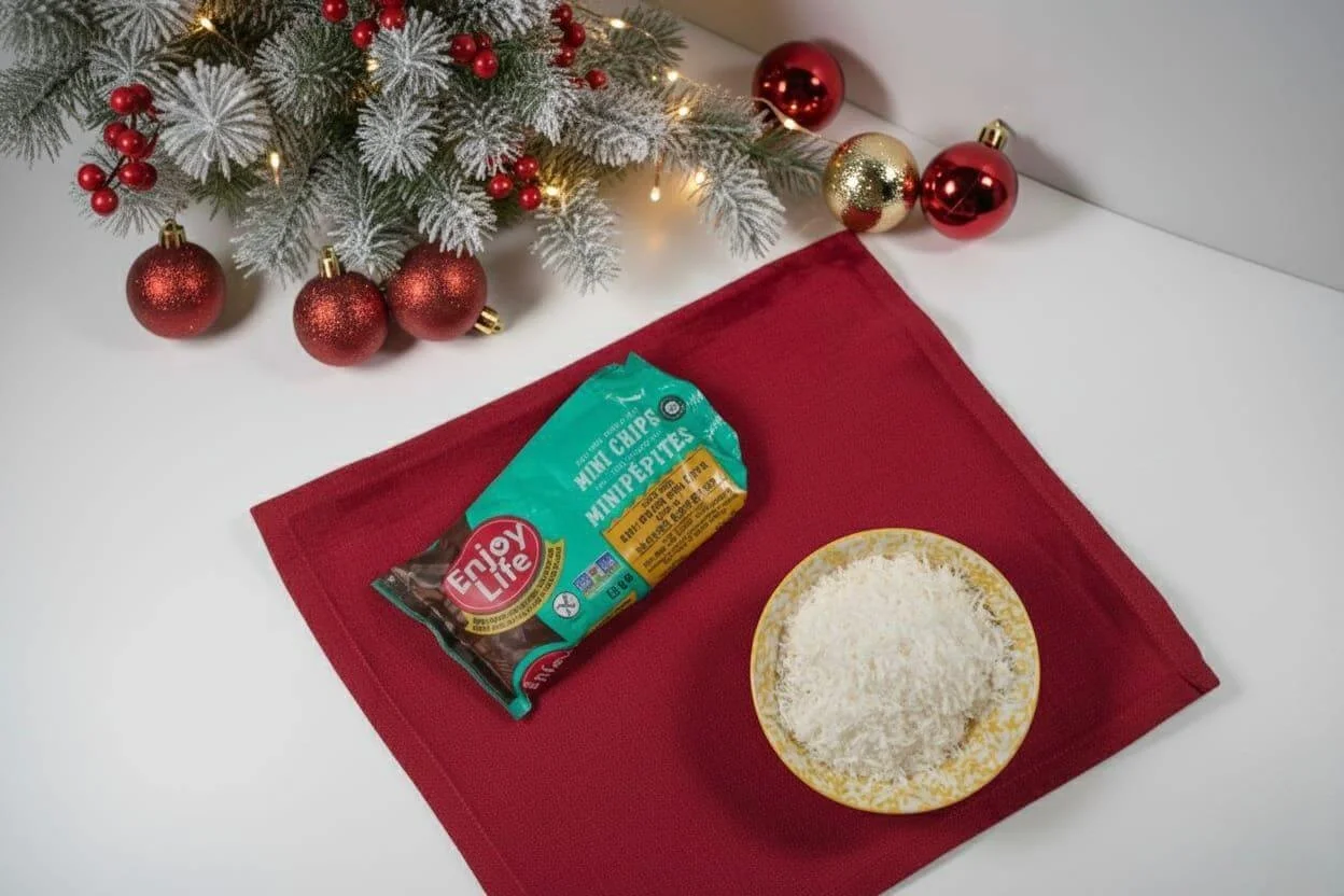 a bowl of shredded coconut and a bag of chocolate chips with christmas ornaments and garland in the background