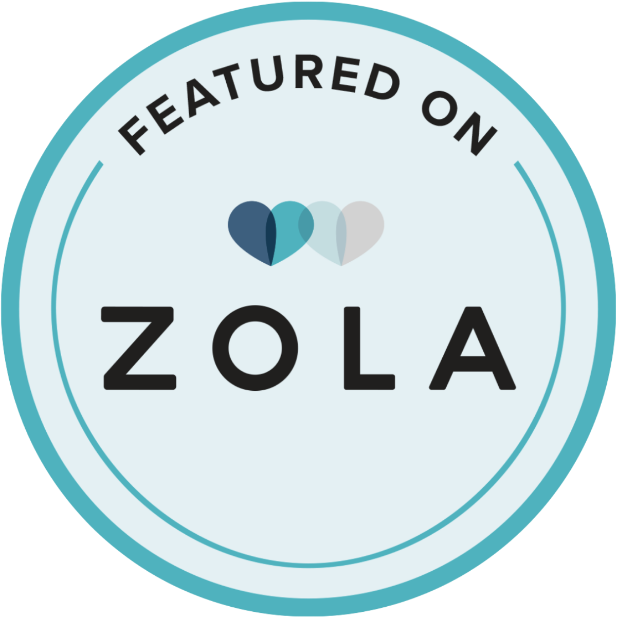 A circular badge with the text "Featured on" at the top and "ZOLA" at the bottom. In the center, there are two overlapping hearts in shades of blue and gray.