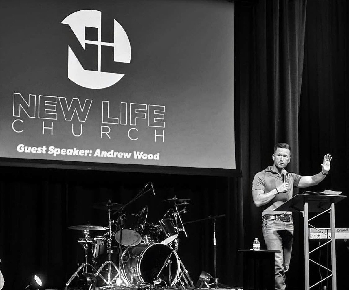 Andrew Wood preaching from a church stage