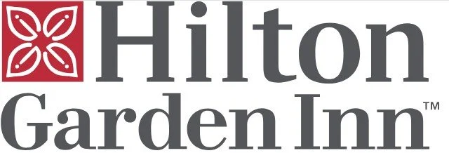 Hilton Garden Inn logo with a red floral symbol and gray text. Image is a link to the corresponding company.