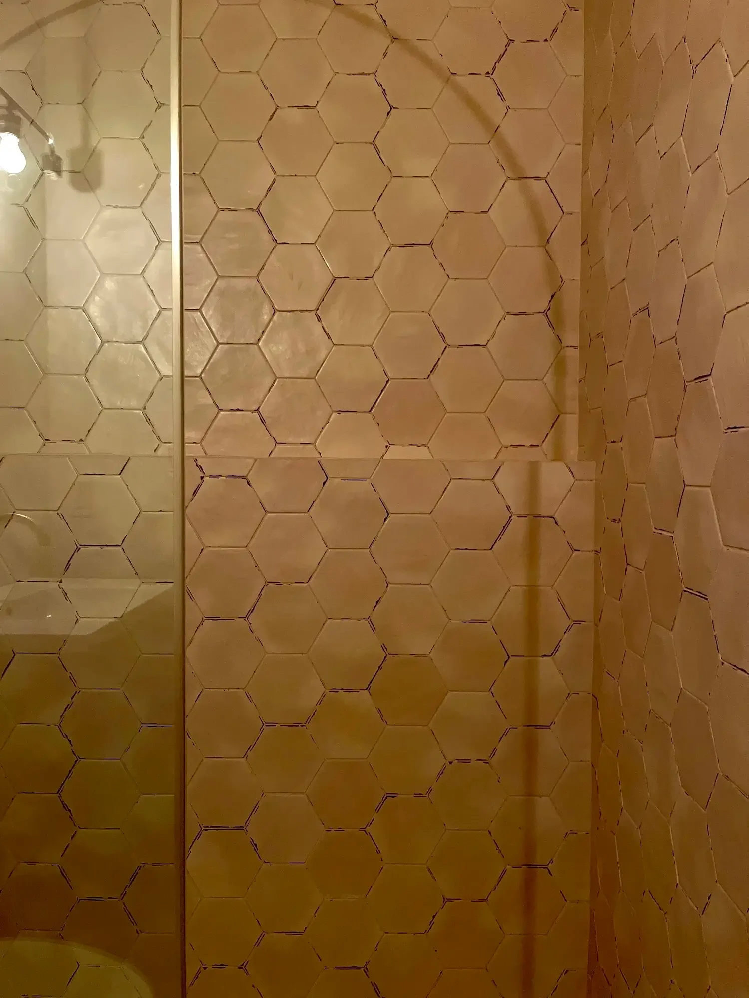 Shower with tile shower walls, glass enclosure, and built-in ledge