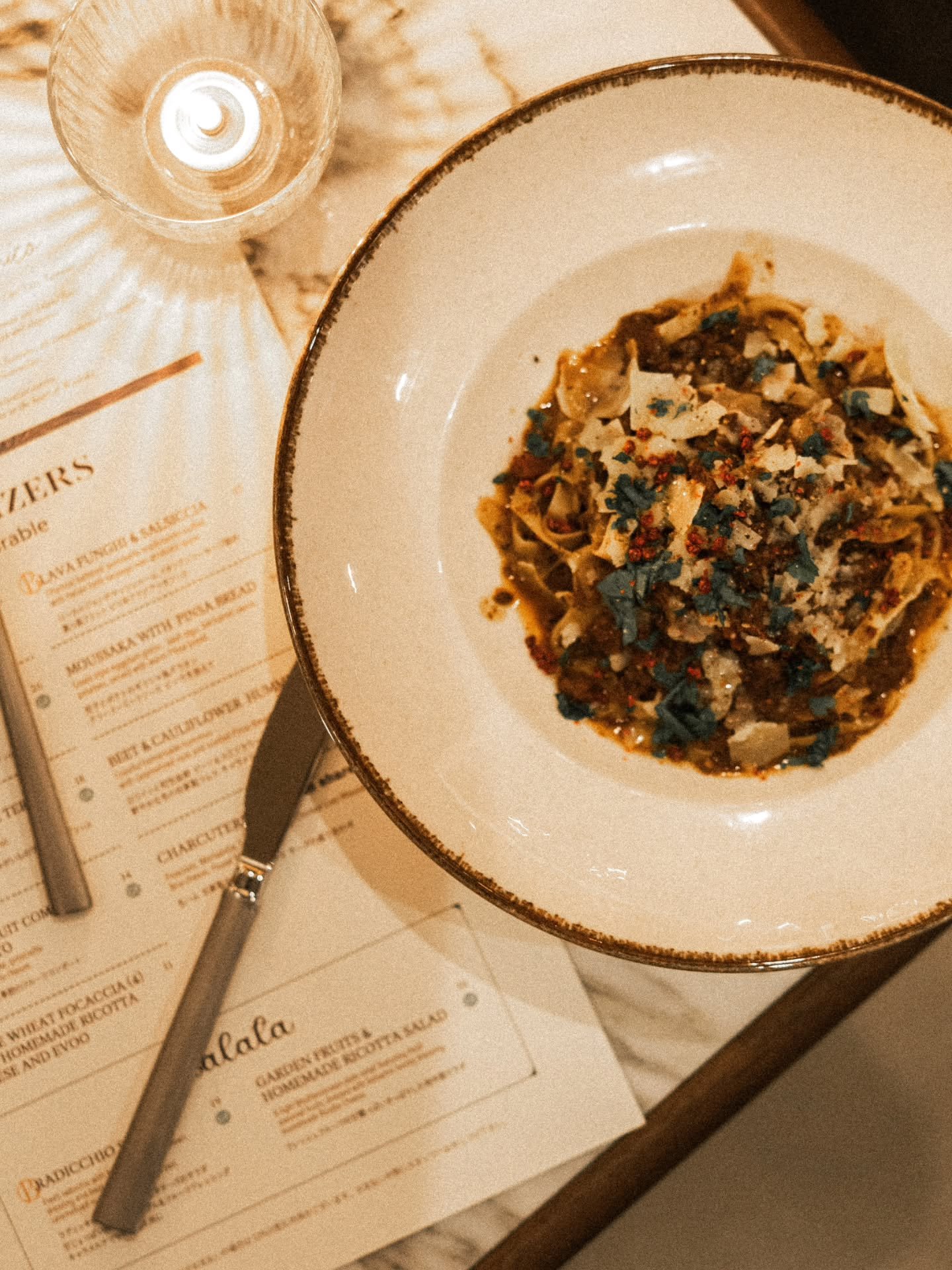 Our House Bolognese: fresh fettuccine in a slow-cooked, homemade bolognese sauce, brightened with Italian parsley, pink peppercorn, and shaved parmesan.

A guest favorite and our most popular dish, served exclusively at dinner from 5&ndash;10PM (last