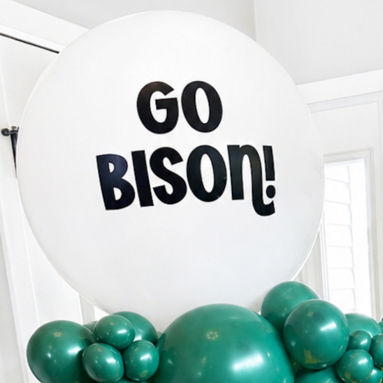 Balloon display with large white balloon reading 'GO BISON!' surrounded by smaller green balloons.