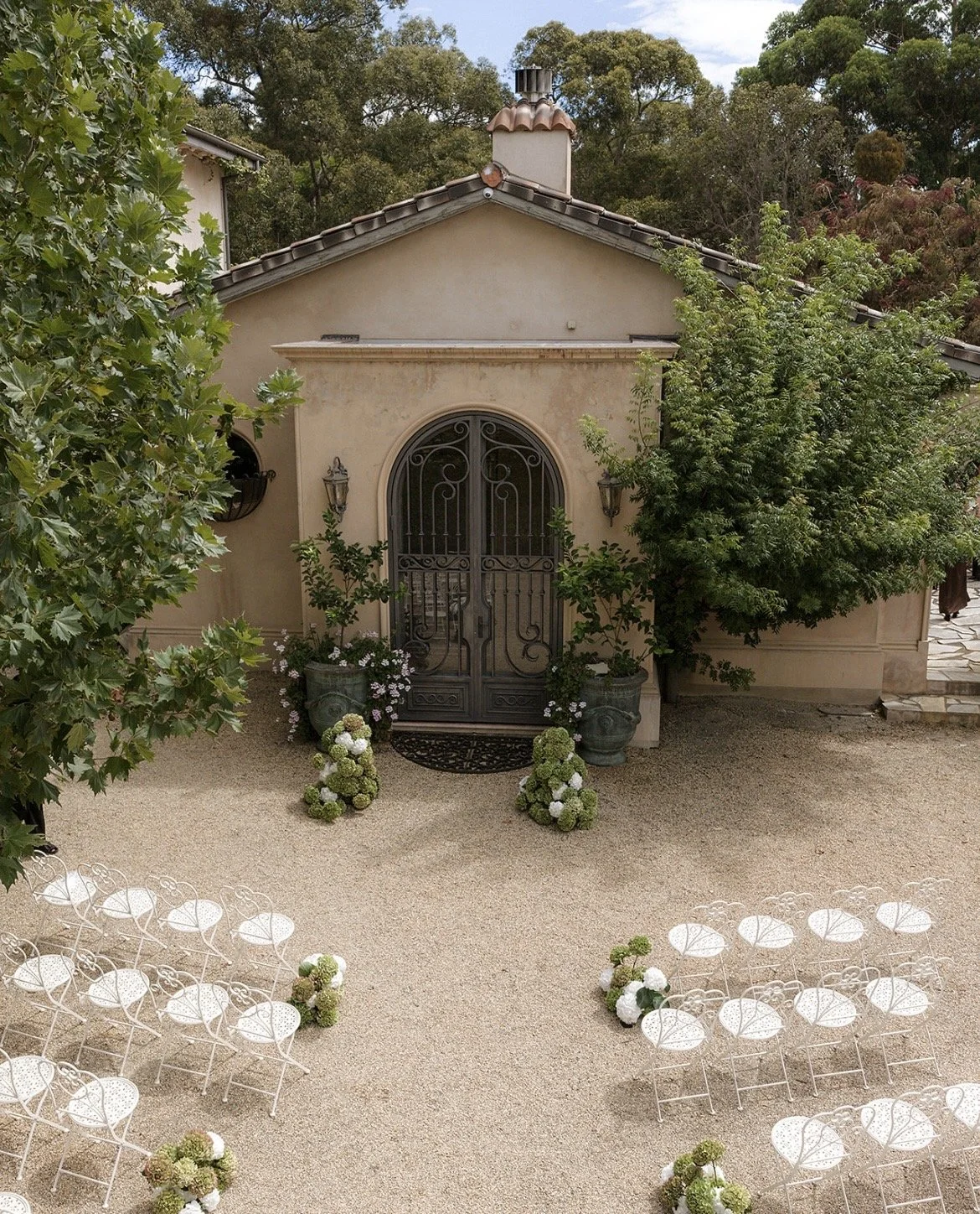 Wedding ceremony with greenery, italian style and white chairs