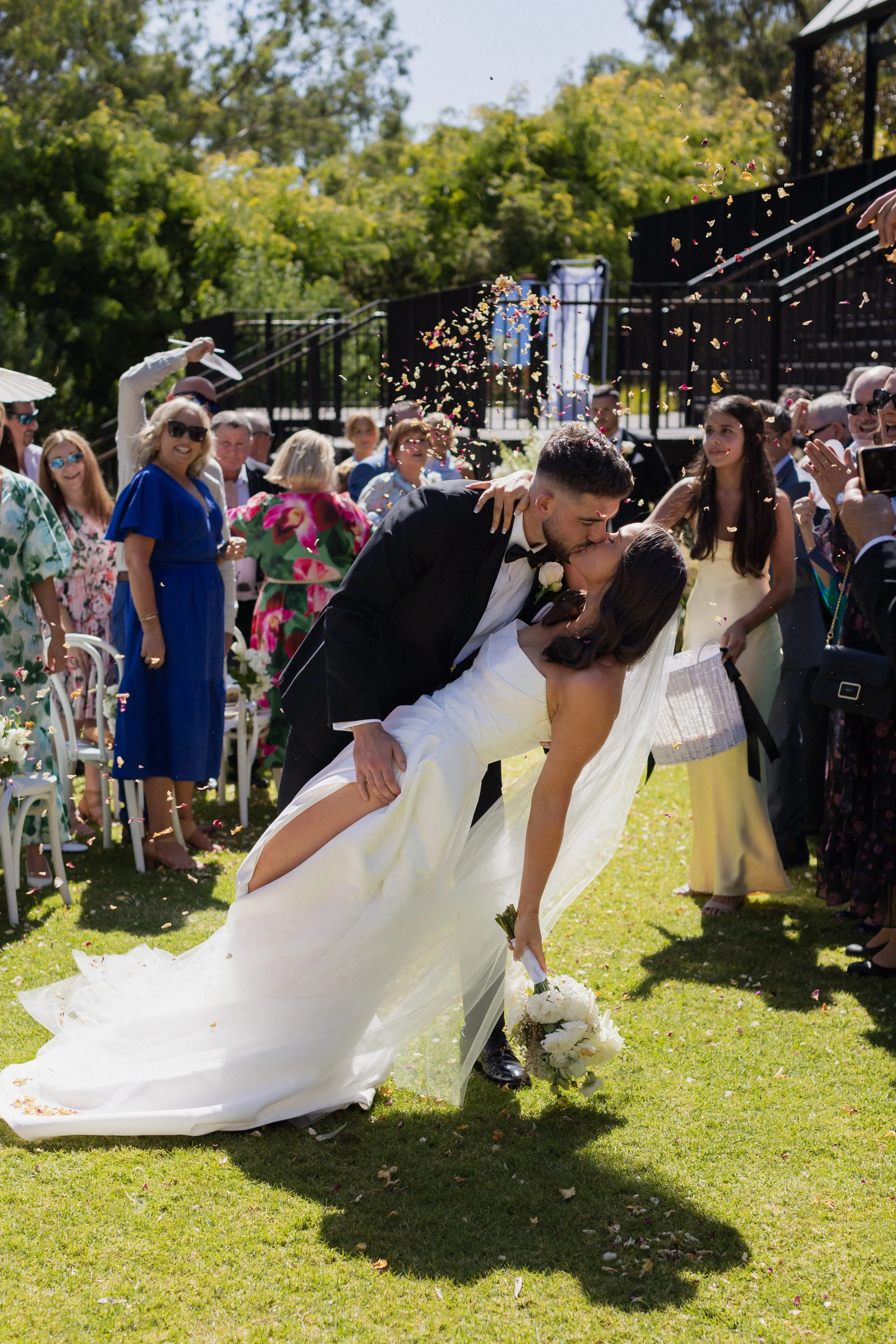 A newly married couple kissing at their wedding ceremony