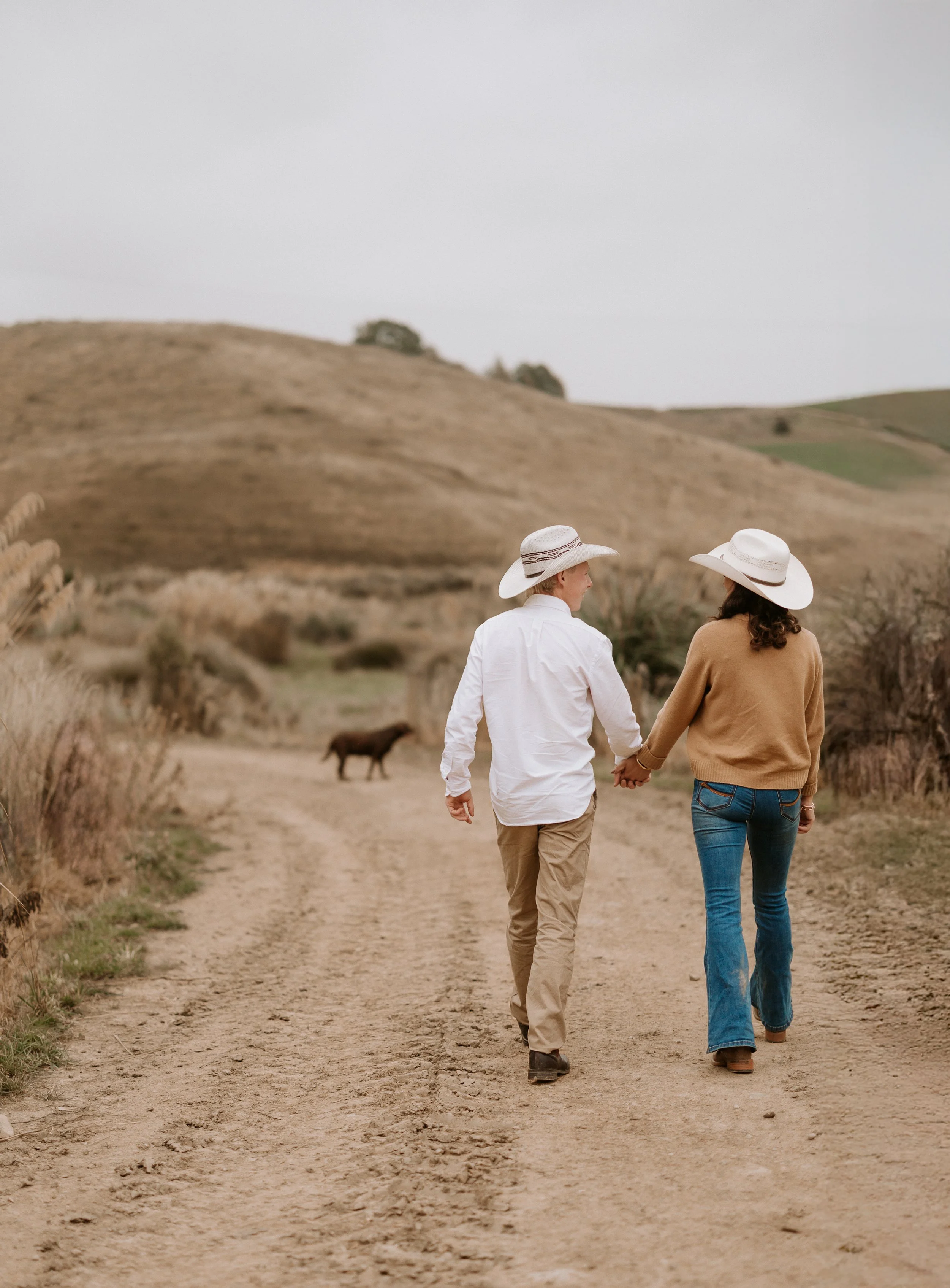 couple walking away from camera holding hands