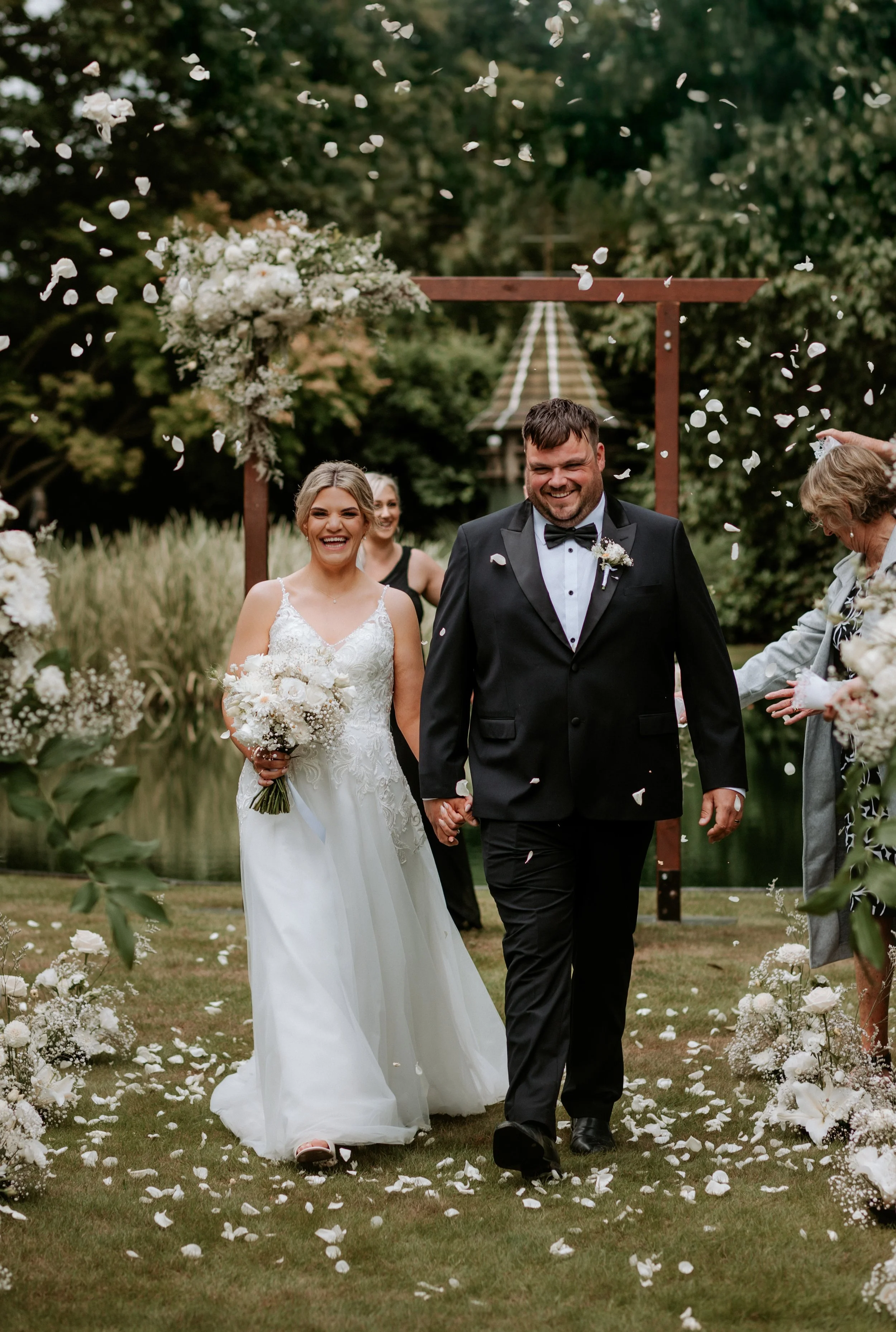 bride and groom walking down the aisle smiling