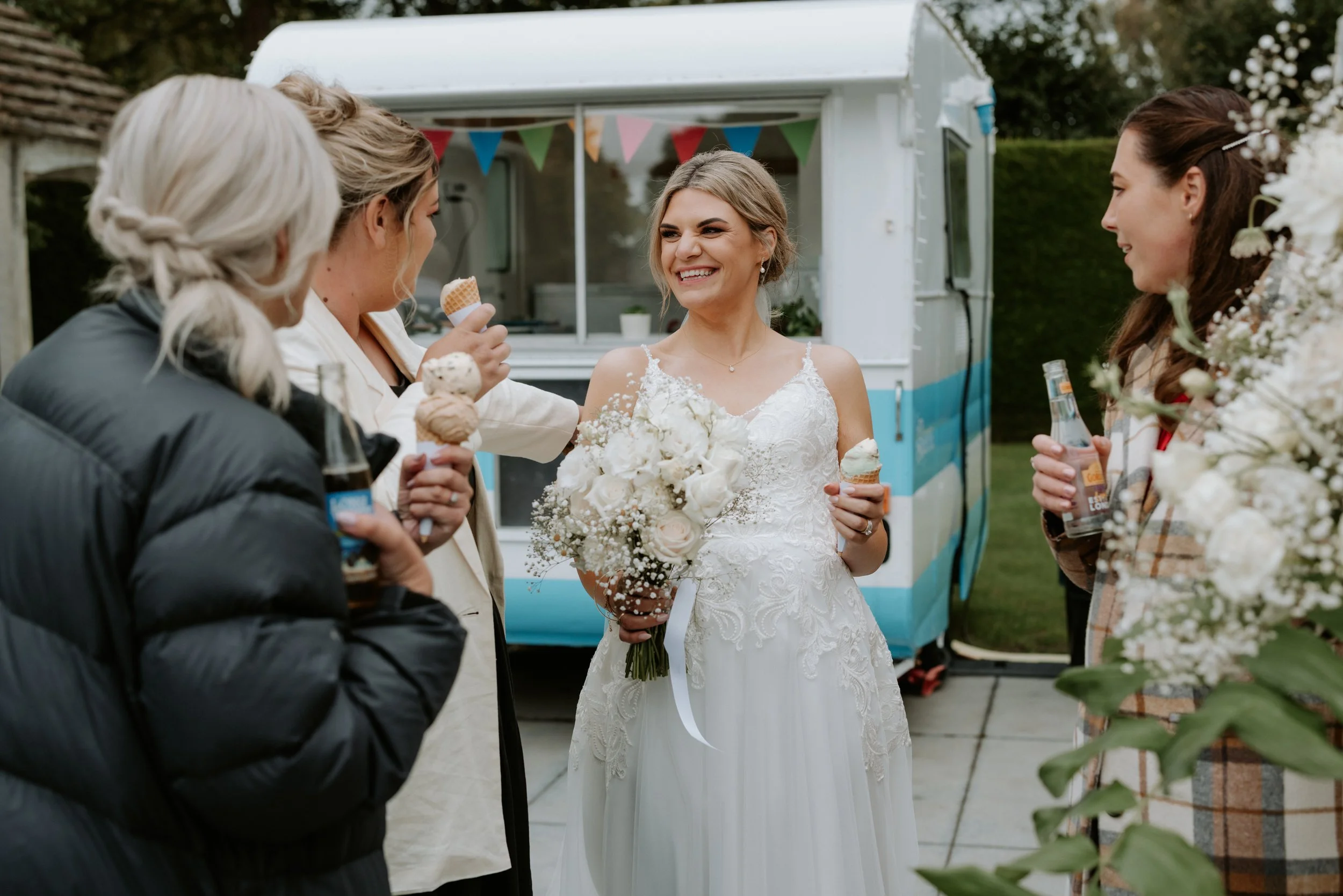 bride laughing with friends and an ice cream
