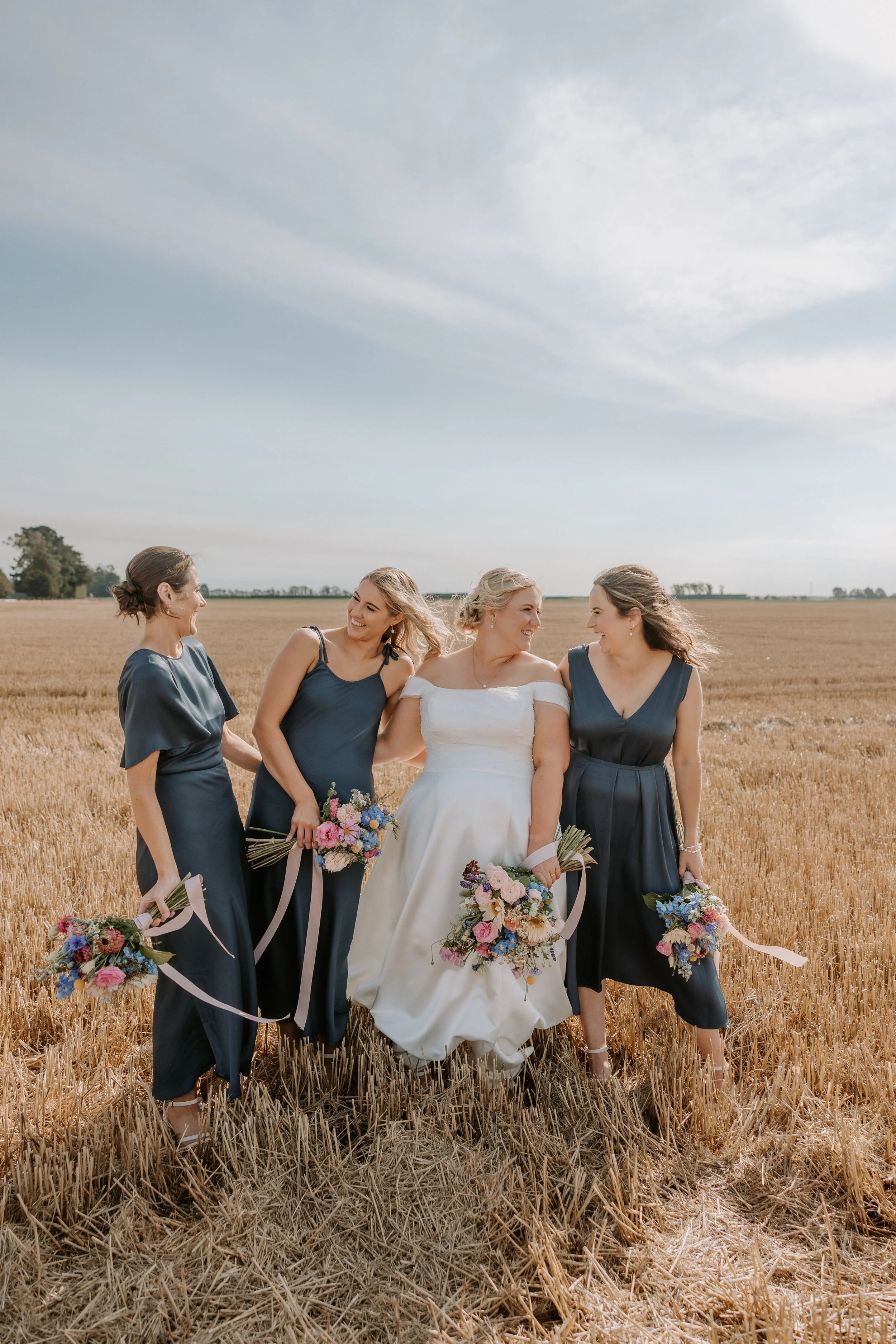 bride and her bridesmaids laughing