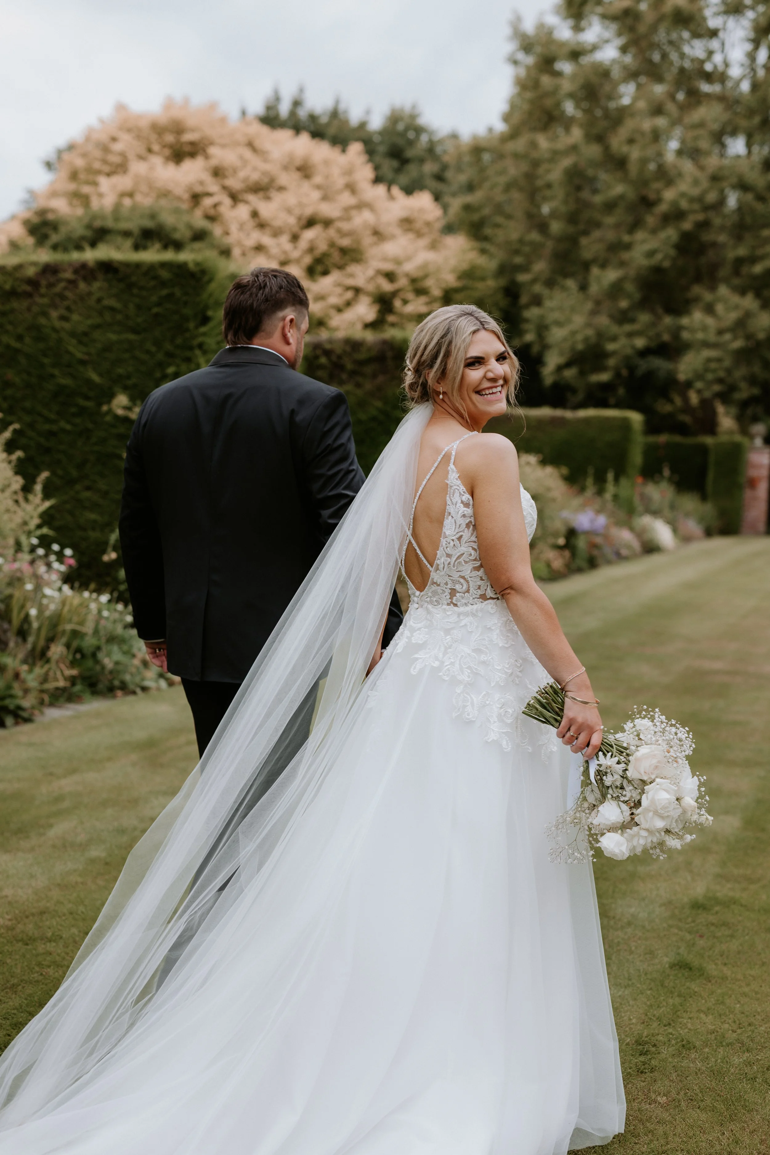 bride looking over shoulder smiling