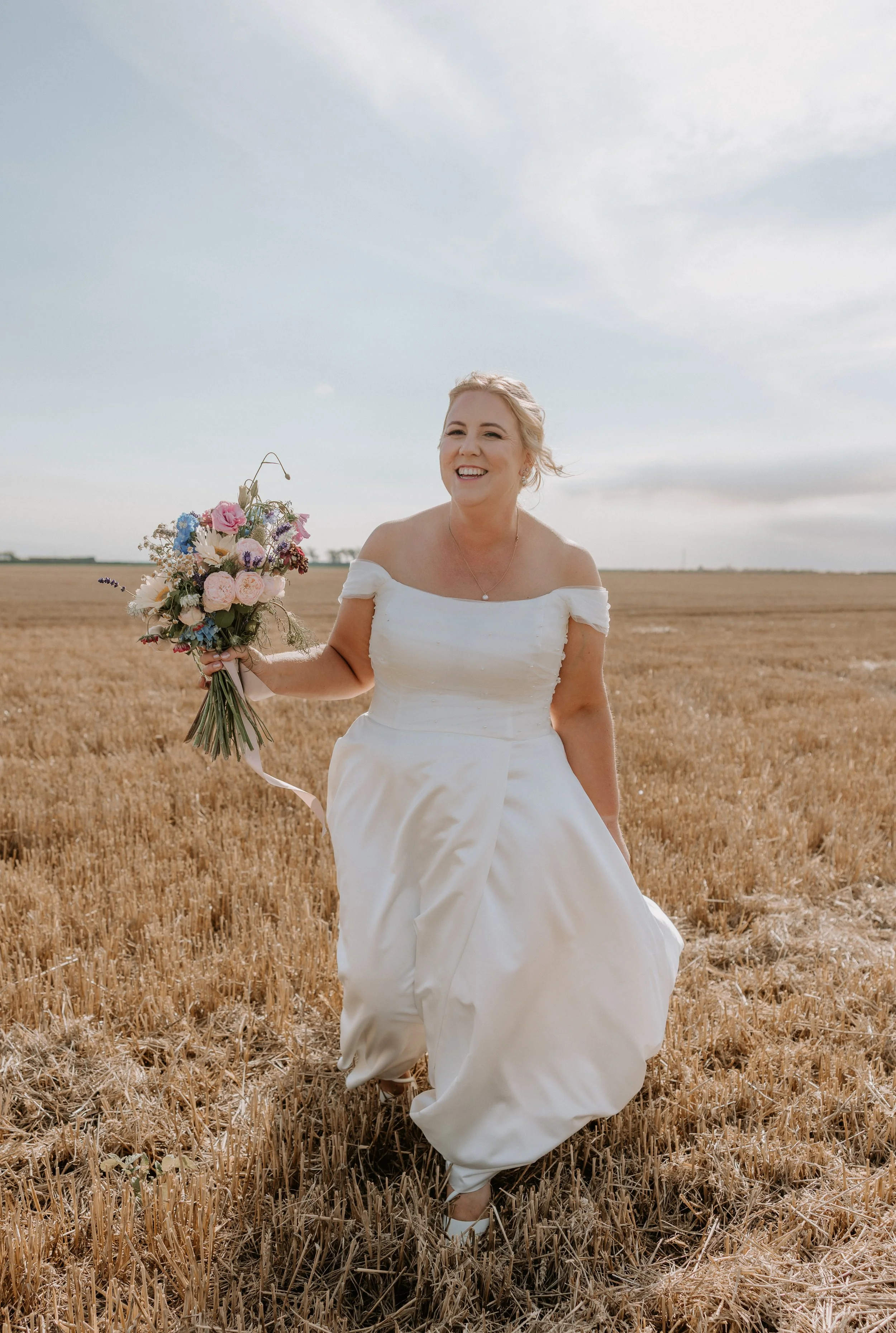 bride walking towards camera during sunset