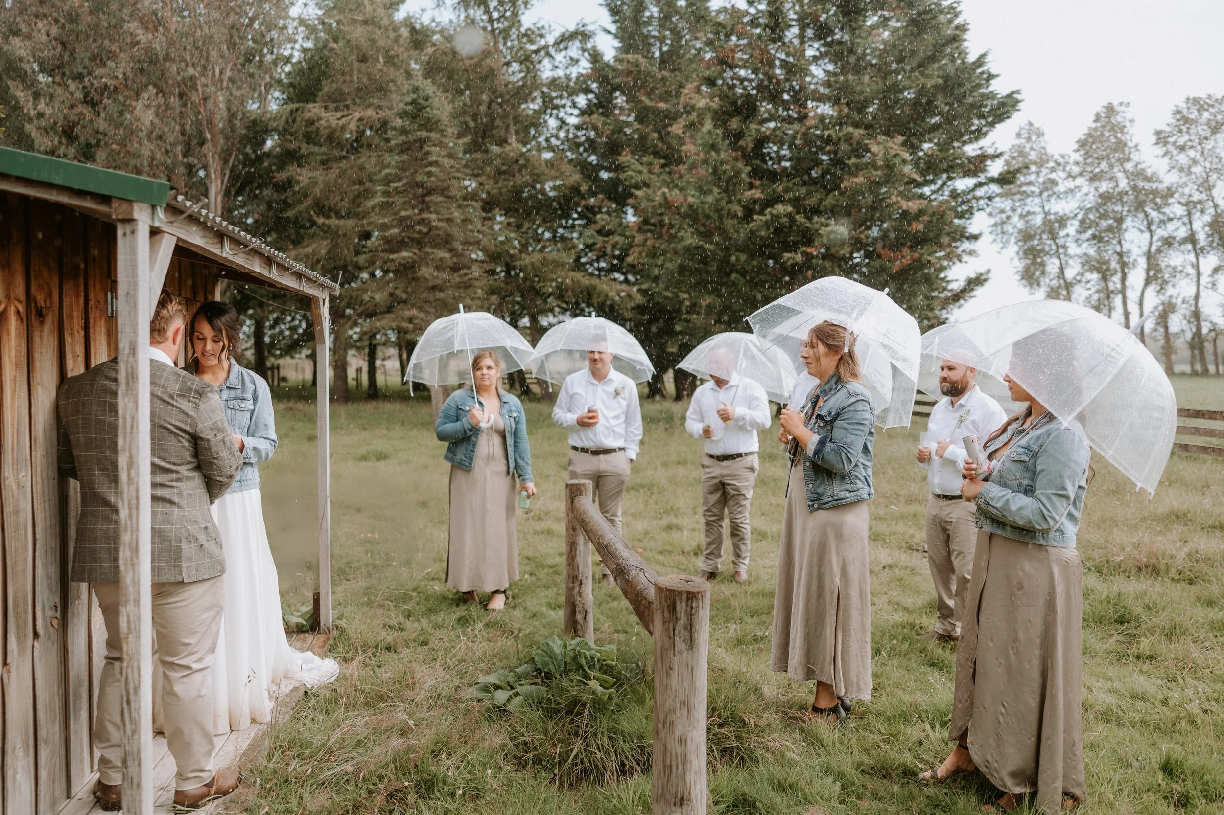 vows during the rain with umbrellas