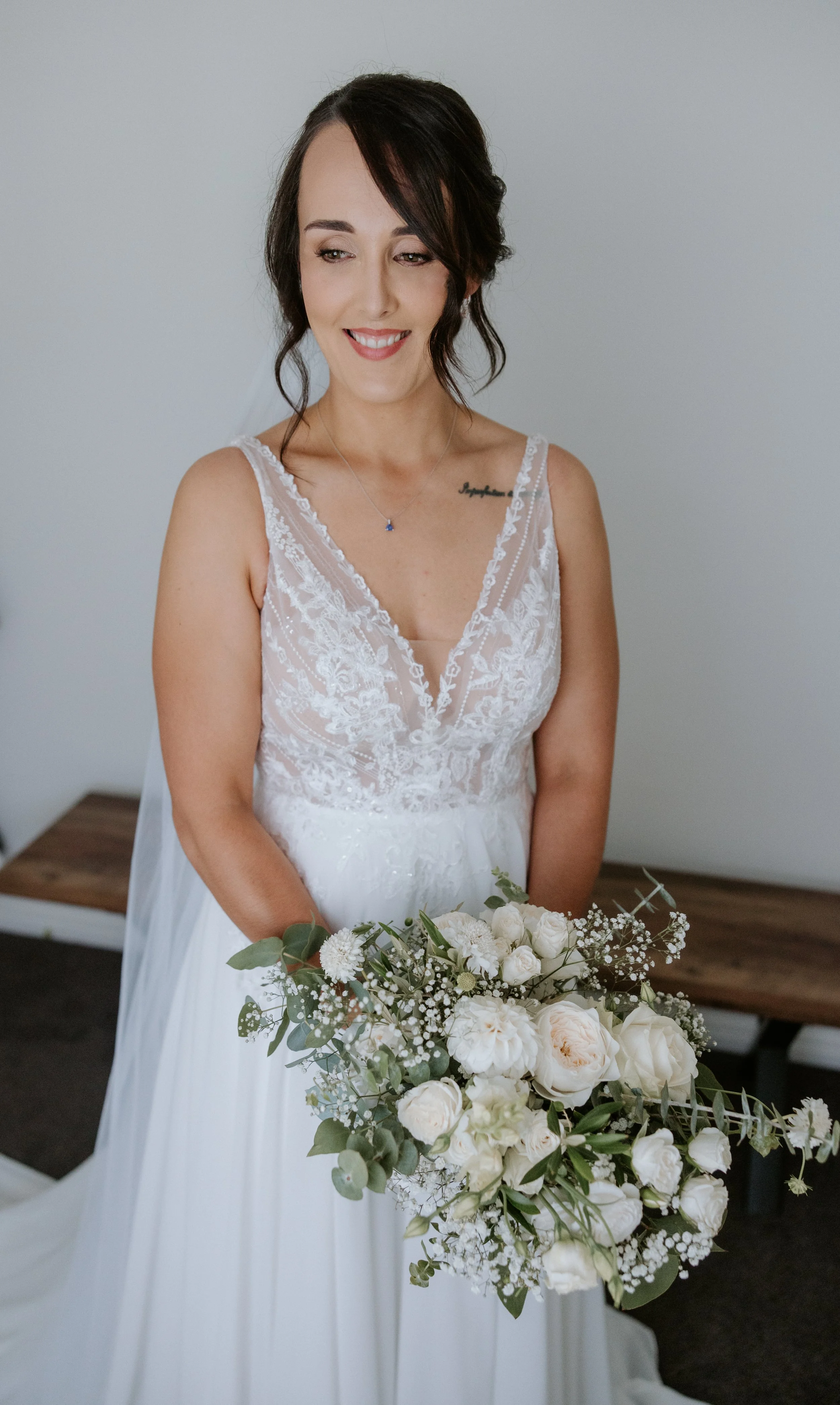 bride smiling with white florals