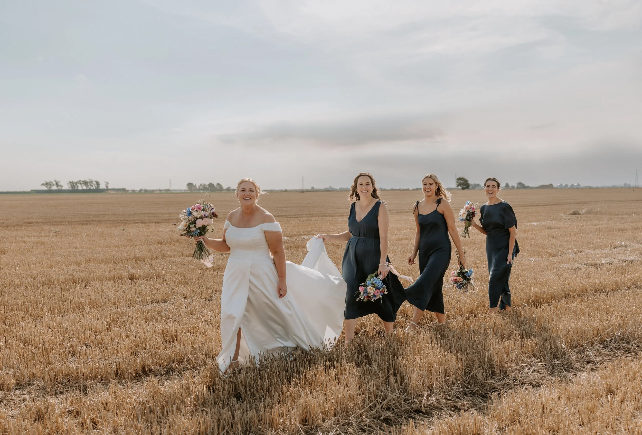 bride and bridesmaids walking during golden hour