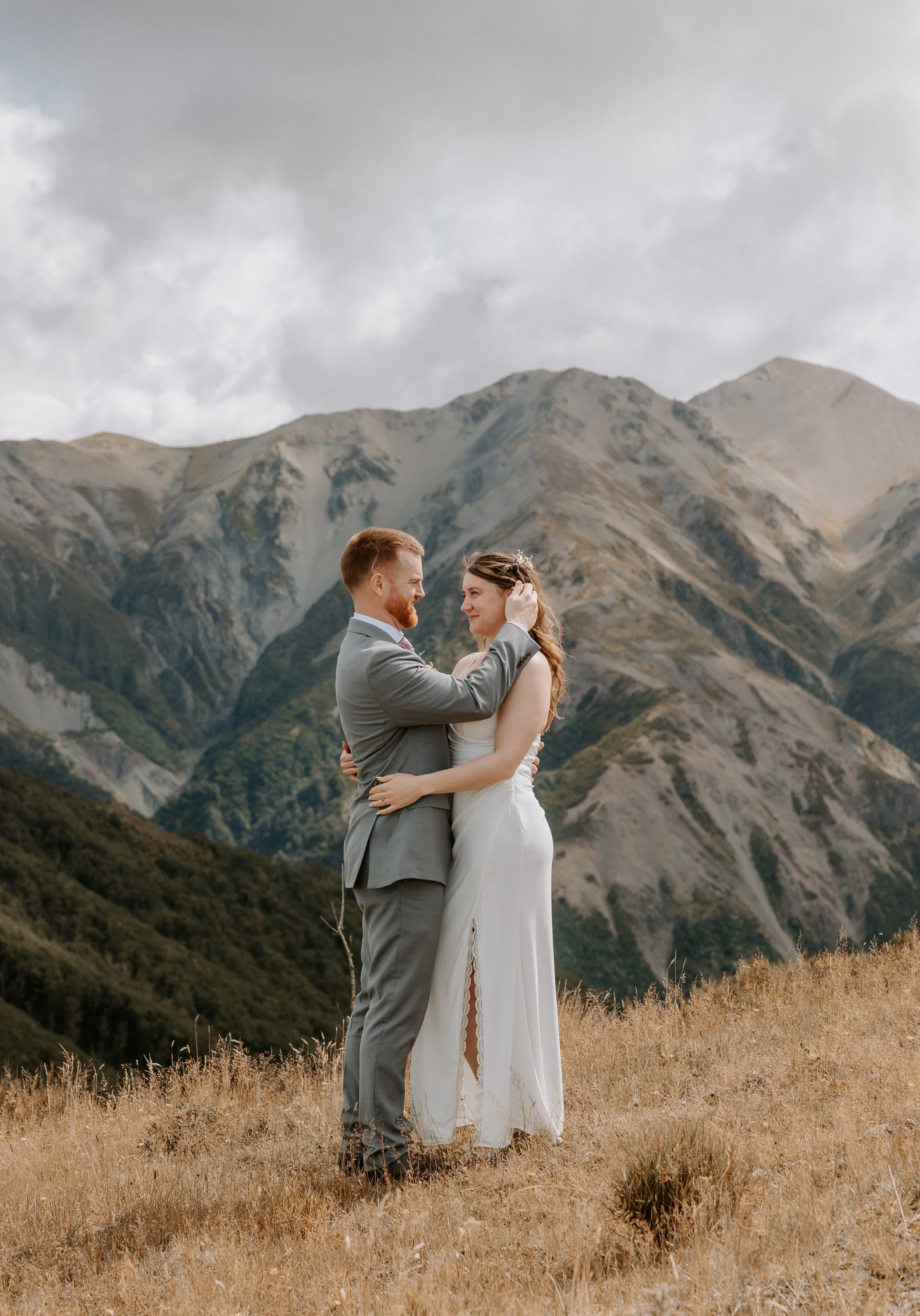 groom tucking hair behind bride's ear