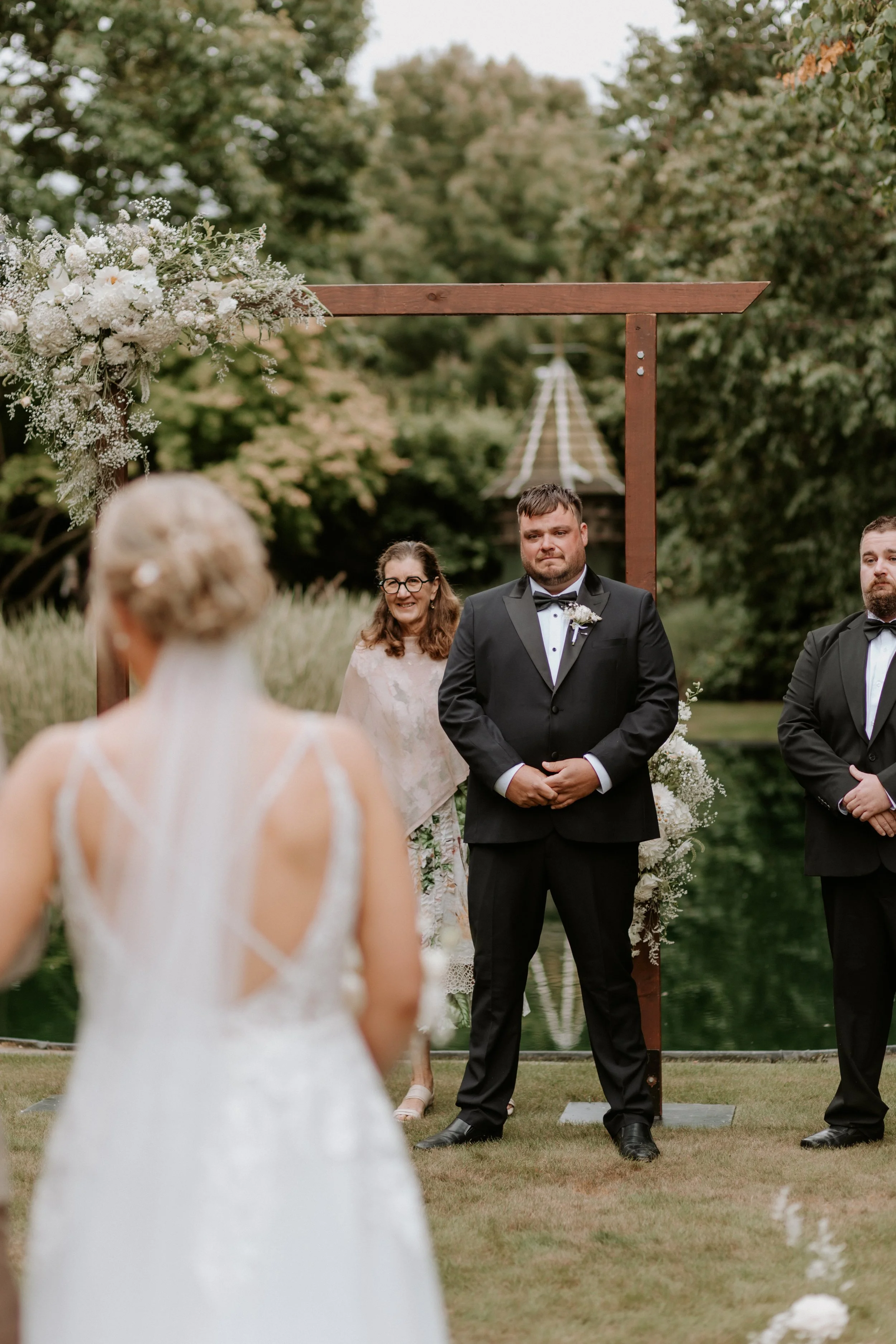 groom reacts to bride walking down the aisle