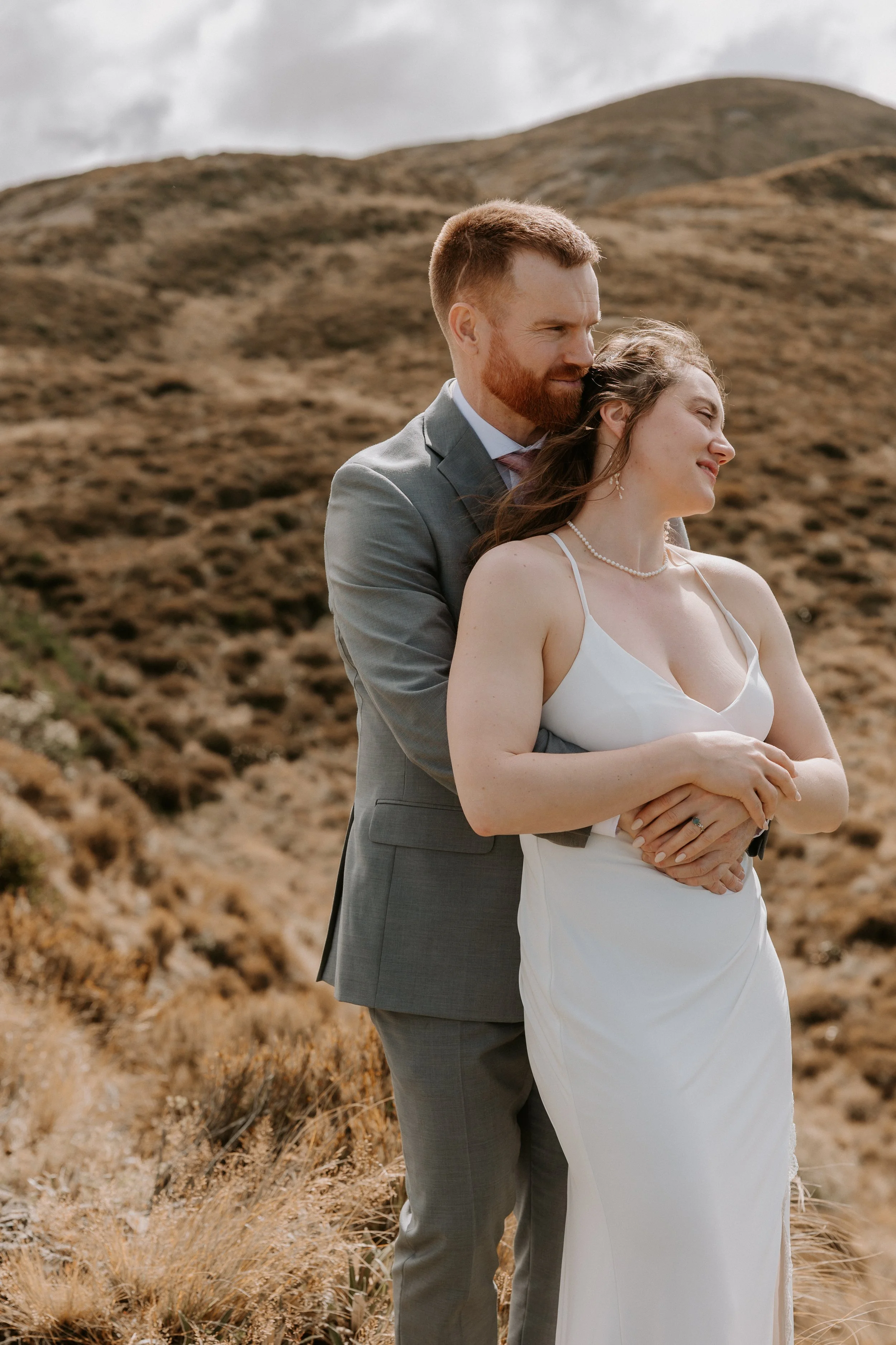 couple embracing on a mountain top