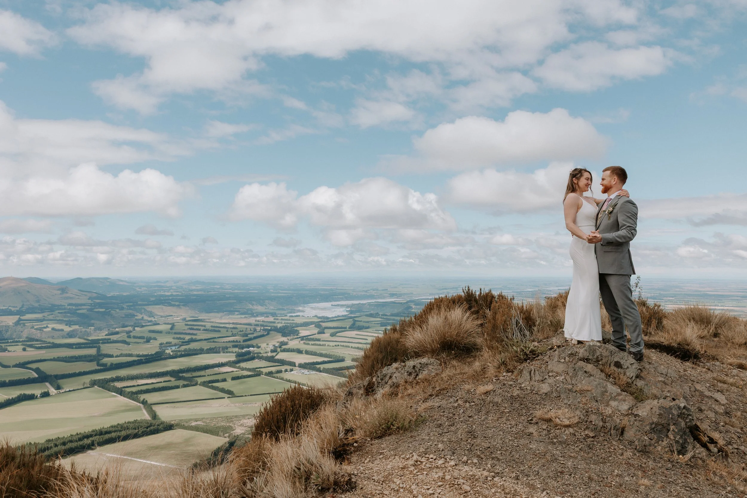 bride and groom staring over Canterbury plains