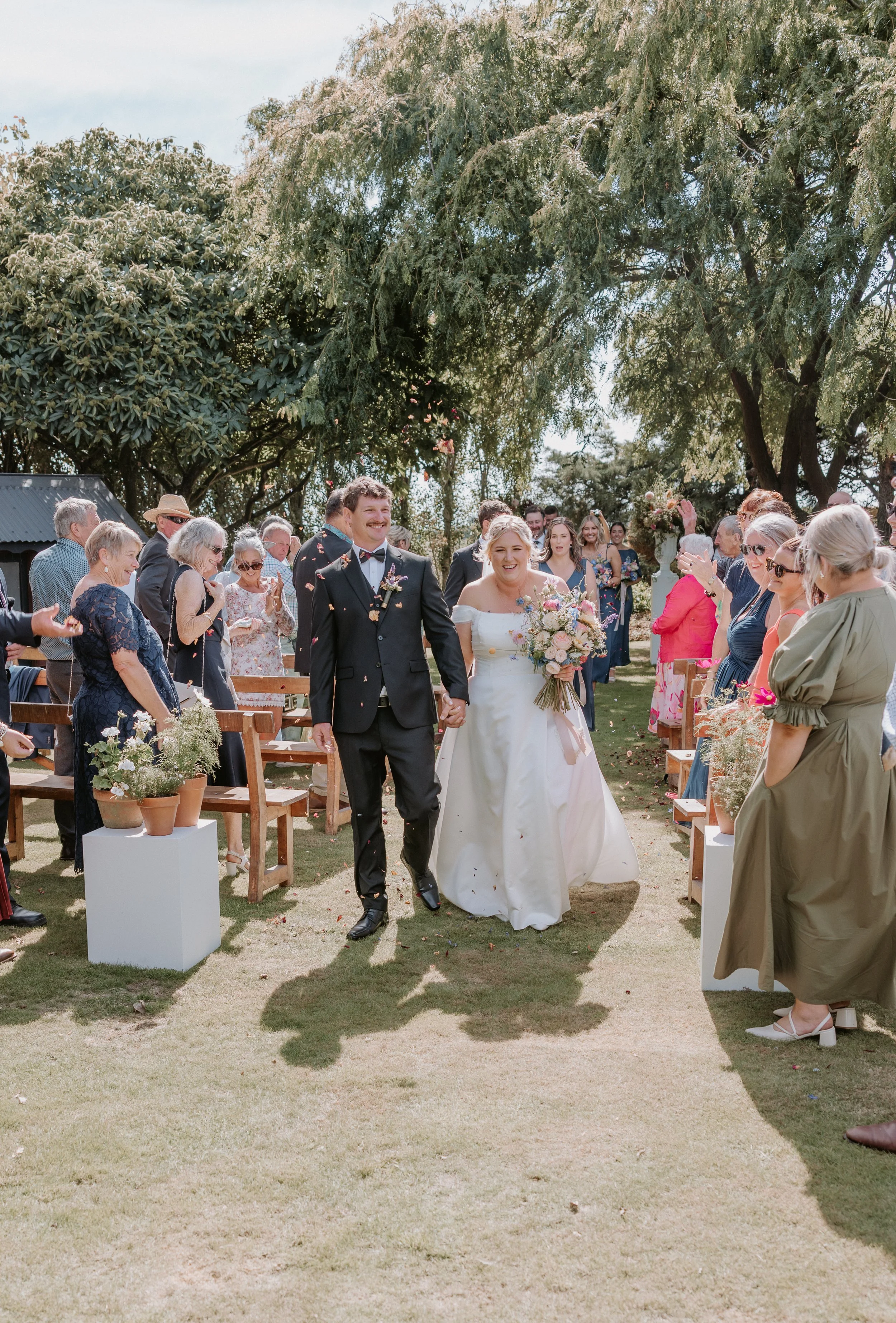 bride and groom walk down the aisle