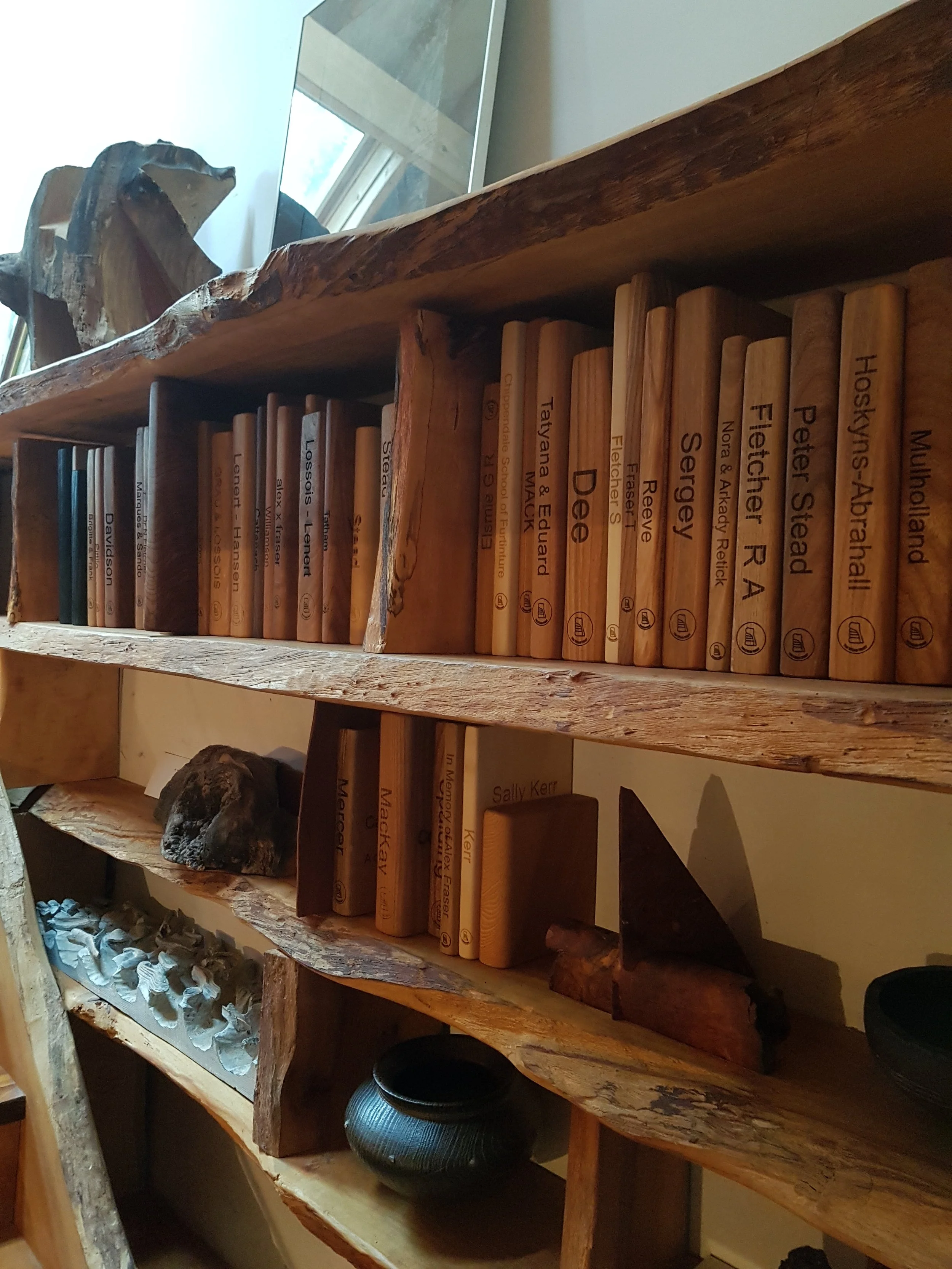 Wooden books on the bookshelf in The Steading
