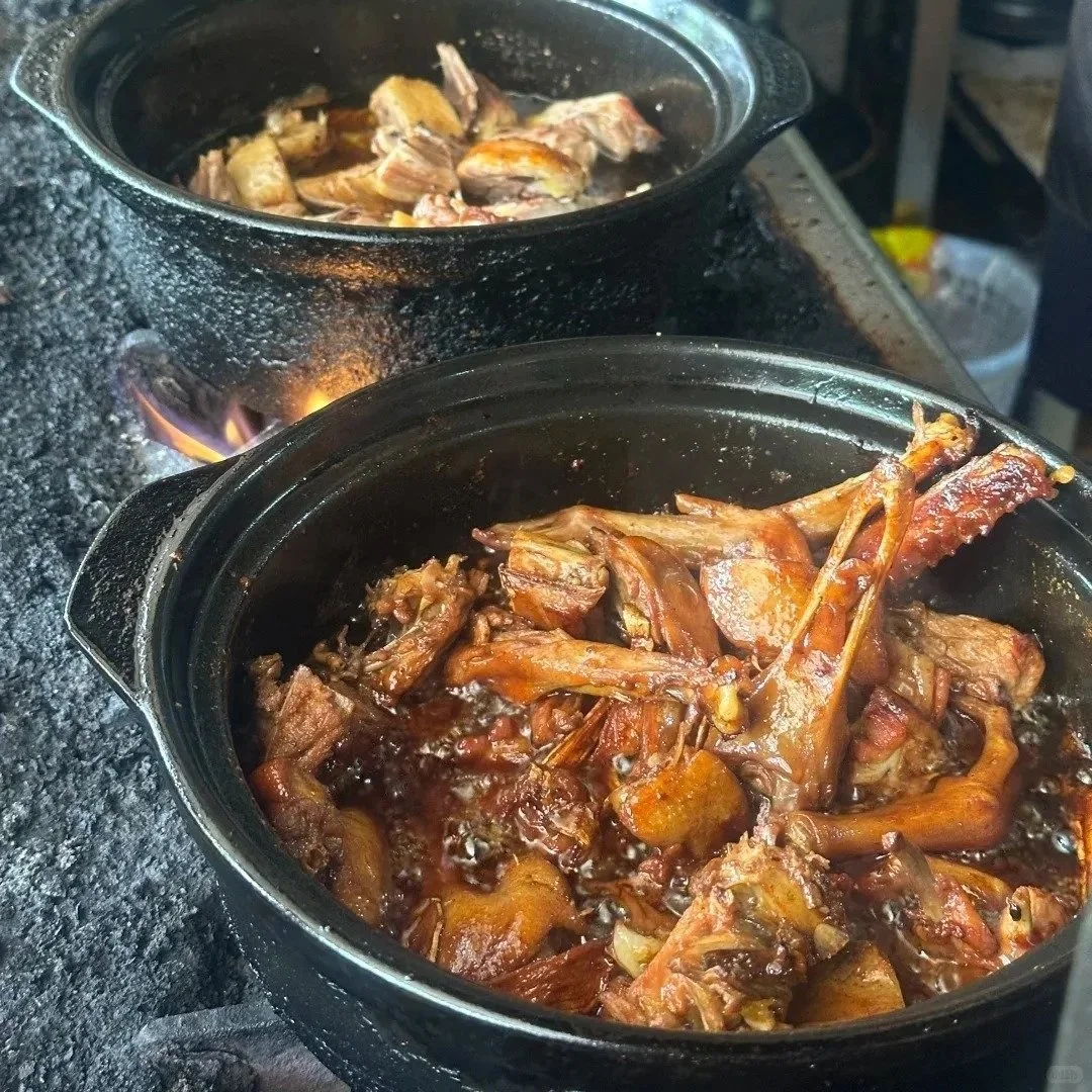 Ginger duck cooking in pots over open flame