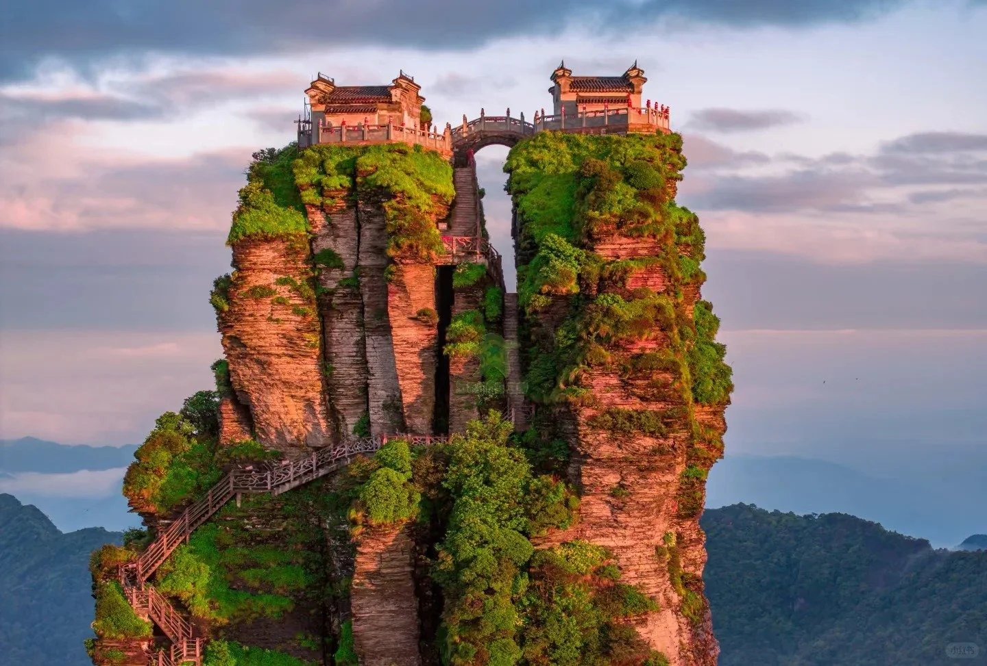 Fanjingshan peak at sunset, with twin temples on top of the spires