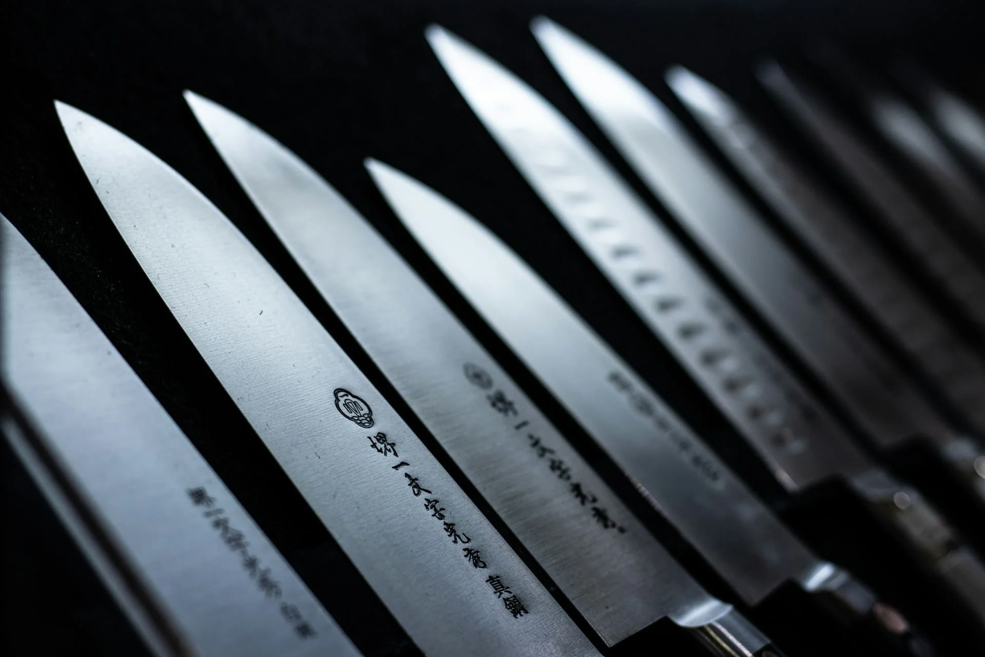Hand-forged Japanese knives displayed in a row at a knife shop in Sakai, Osaka