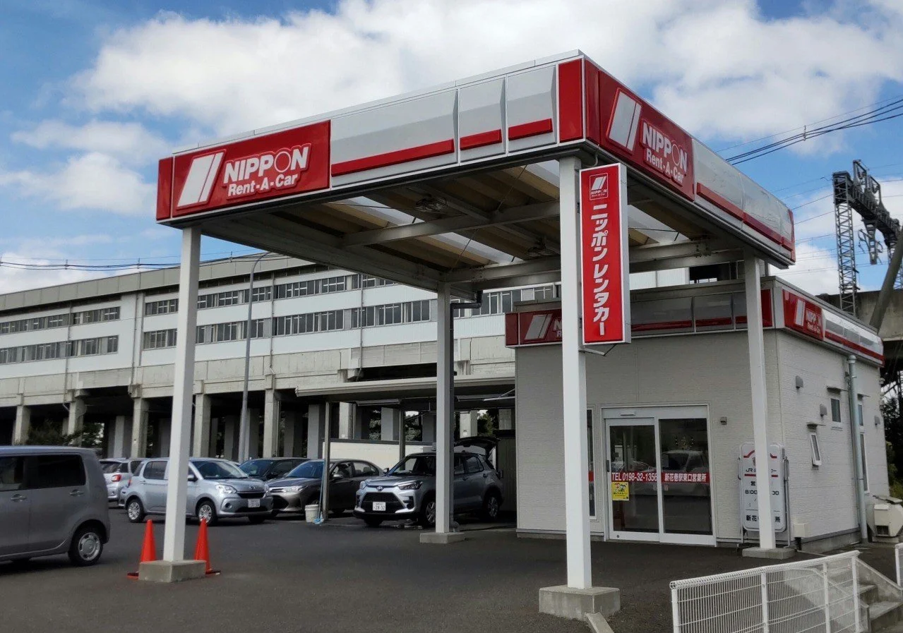 A Nippon rent-a-car shop in Japan with cars available in the lot