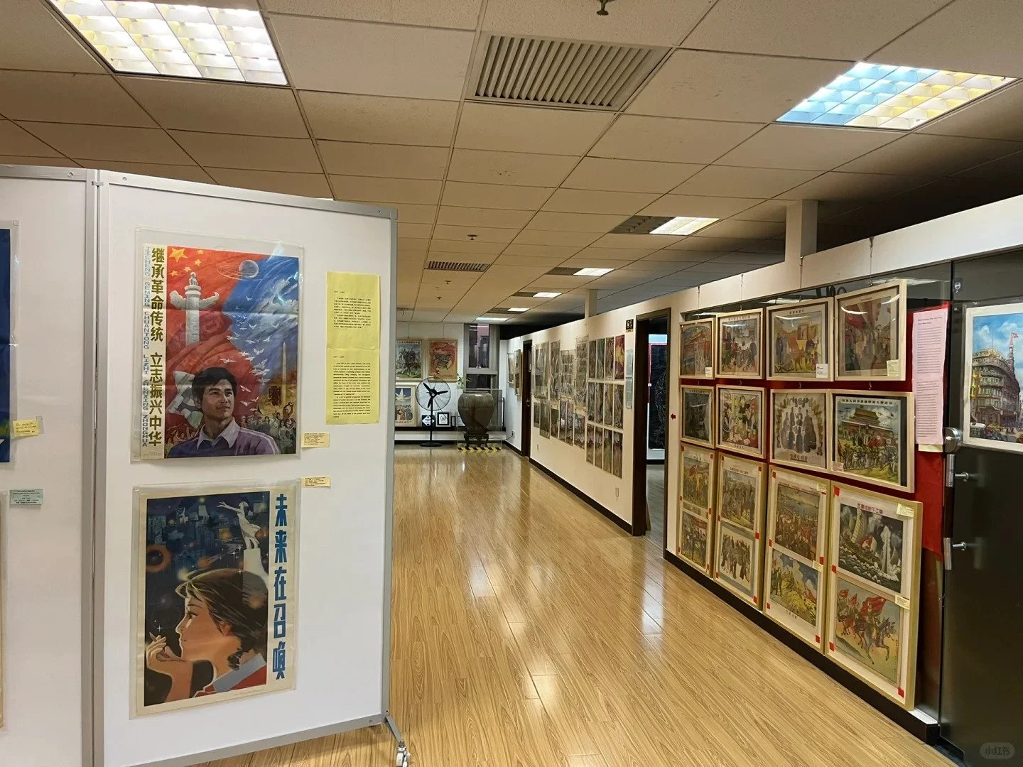 Old propaganda posters in frames with Chinese writing hanging on the walls of the Propaganda Poster Art Centre in Shanghai