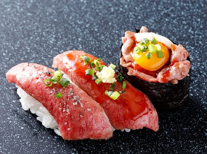 Hida beef wagyu nigiri and gunkan sushi topped with egg yolk, from Hida Kotte Gyu in Takayama