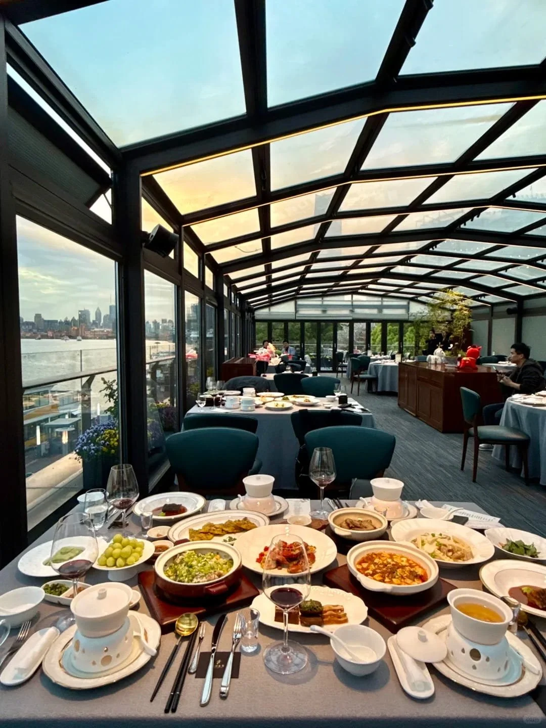A spread of Ningbo cuisine dishes at Yongfu in Shanghai, with views across the Huangpu River