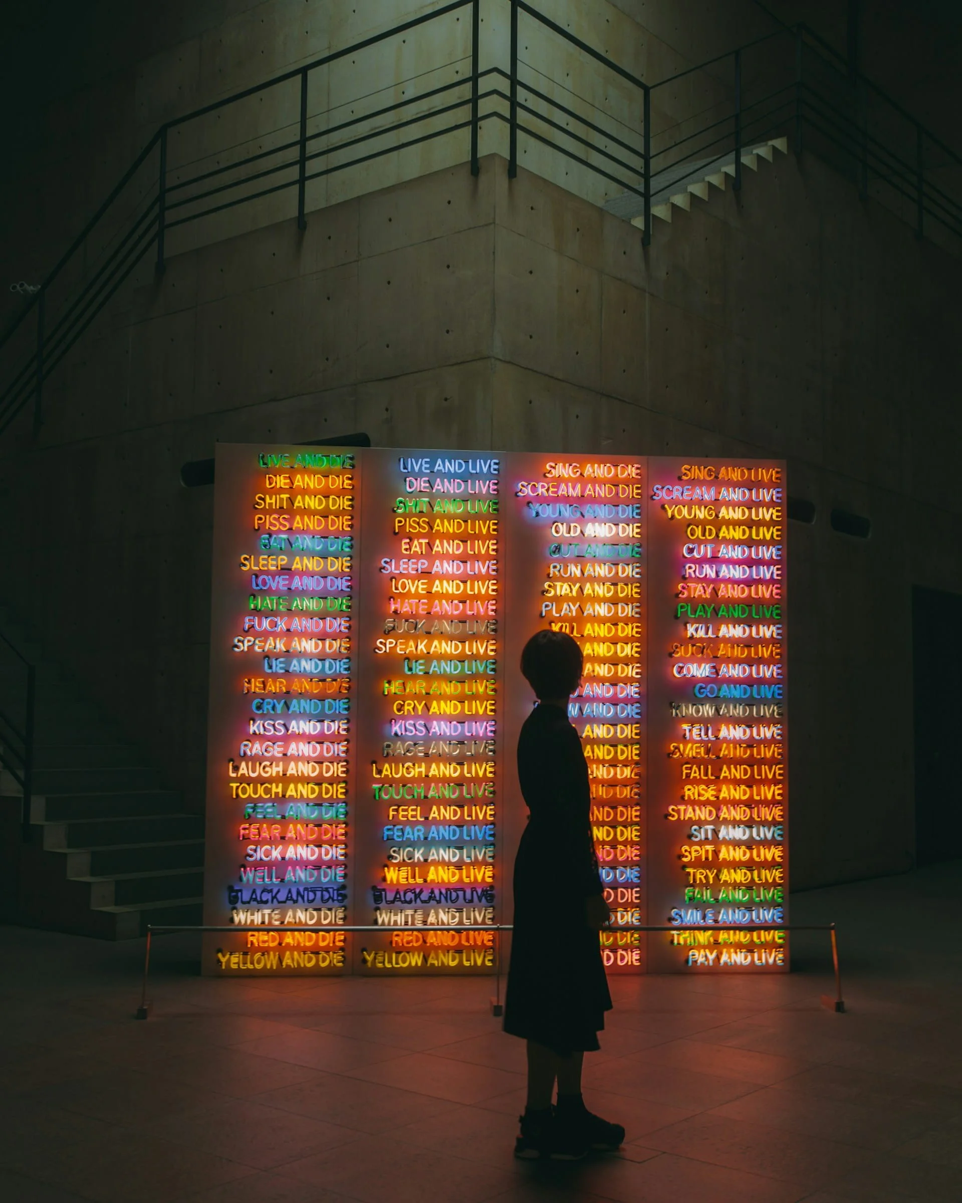 Silhouette of a woman standing in front of a lit up art exhibit at the Benesse Art Site on Naoshima island, Seto Inland Sea