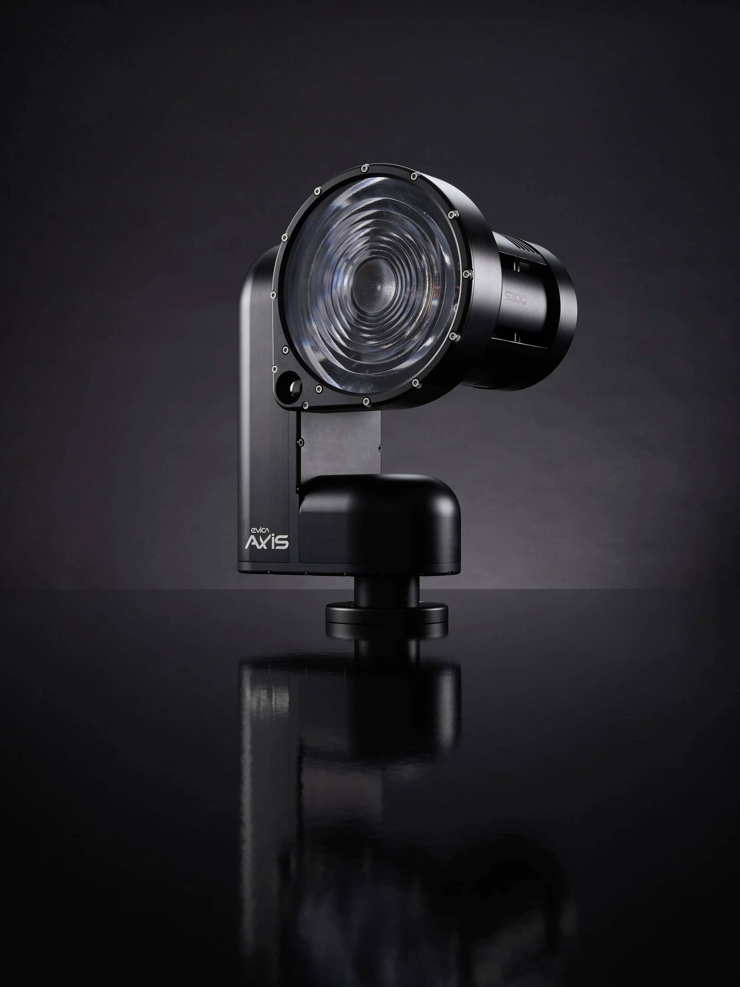 A professional camera mounted on a tripod against a dark background.