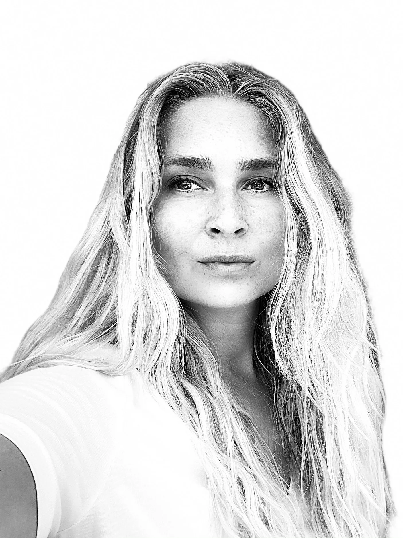 Black and white portrait of a woman with long wavy hair, wearing a short-sleeved top, looking slightly to her right.