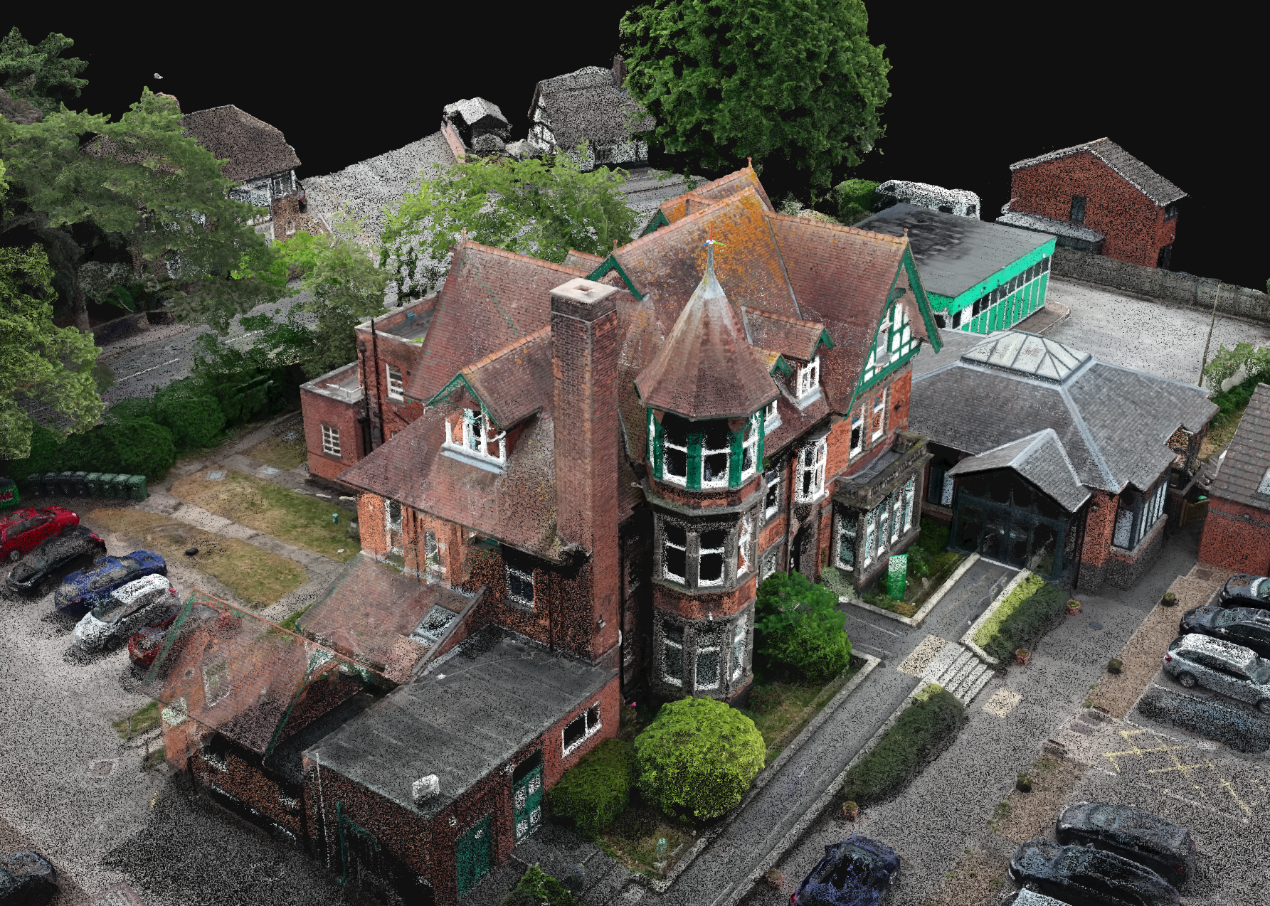 A Point cloud view of a large, ornate brick house with multiple steeply pitched roofs, a turret, and bay windows, surrounded by parking lot and trees.