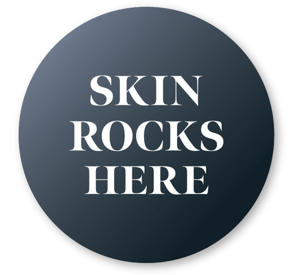 Circular label with gradient background and white text that says "Skin Rocks Here."
