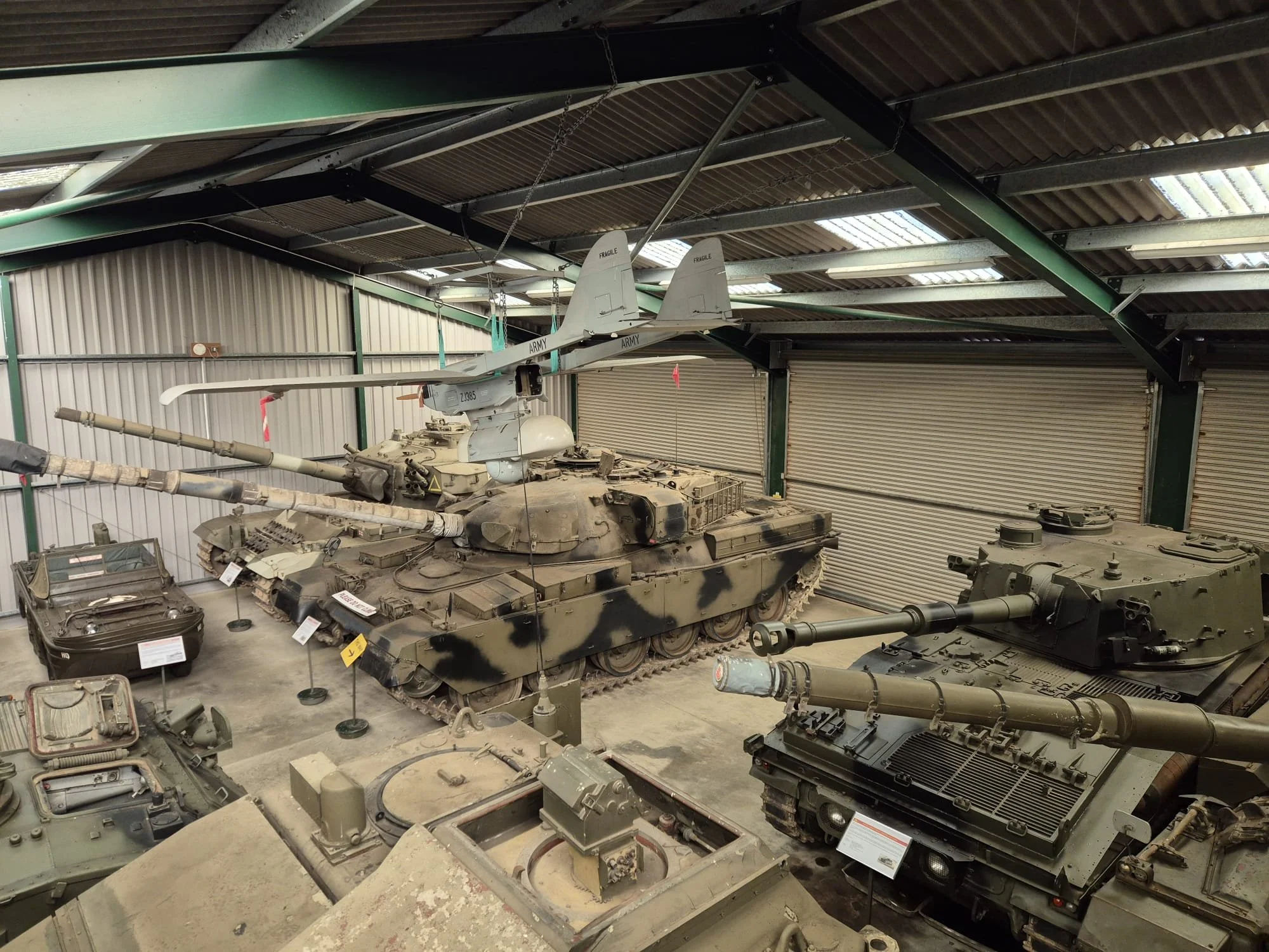 Military tanks and armored vehicles displayed in a museum.