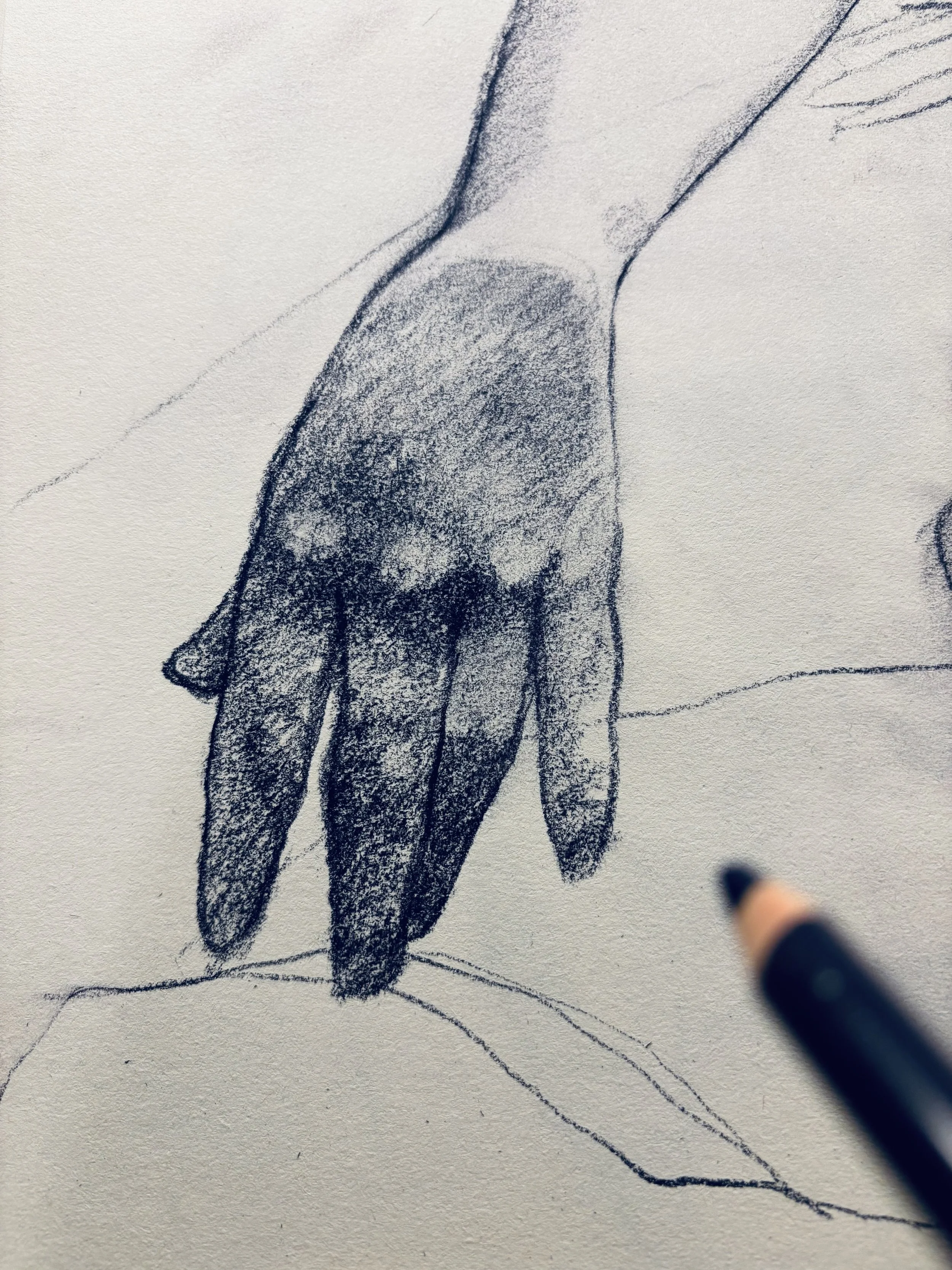 A detailed pencil sketch of a hand resting on a surface, with a person's arm partially visible in the background.