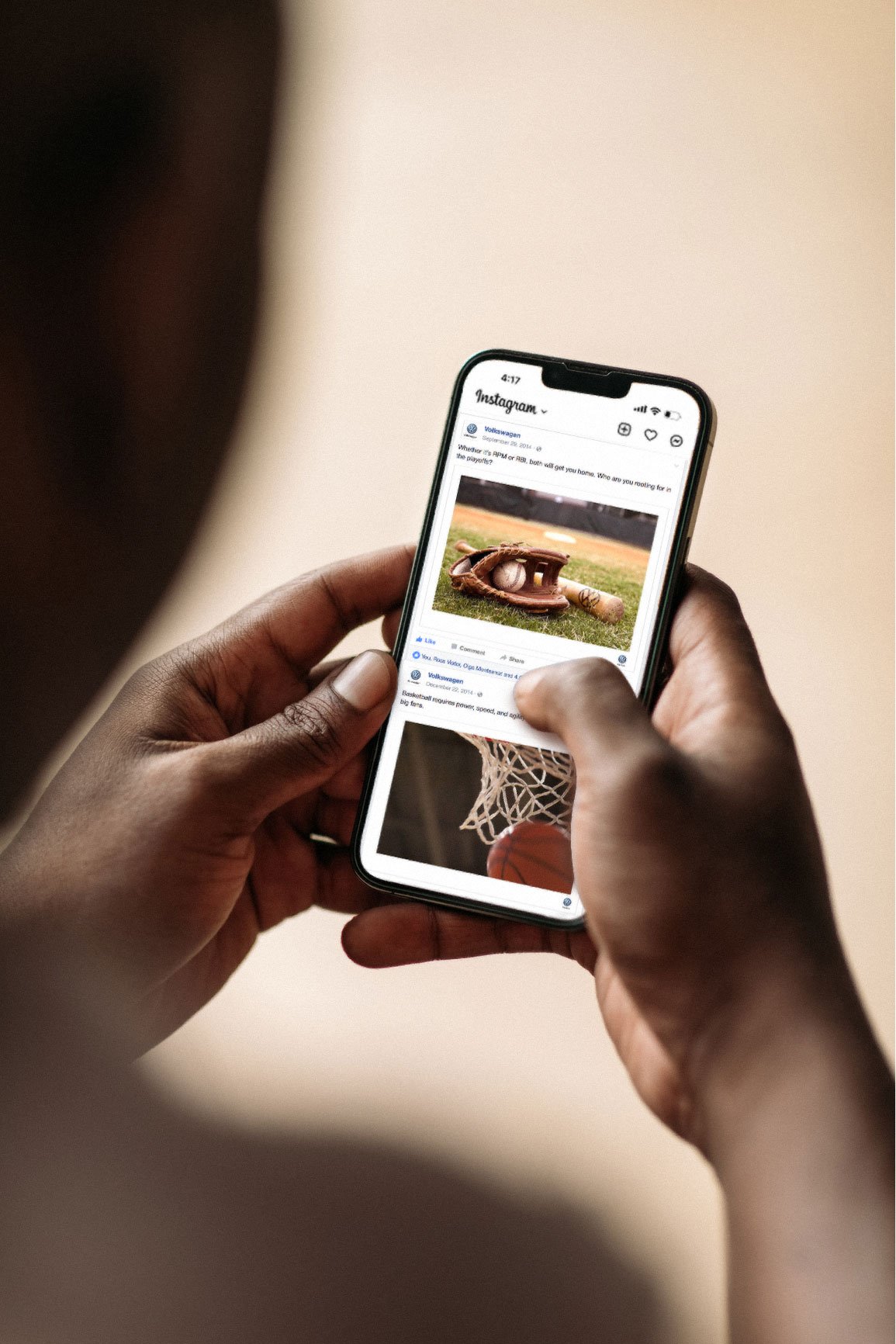 Person holding a smartphone browsing an Instagram post featuring a baseball glove, baseball, and a bat on an outdoor baseball field.