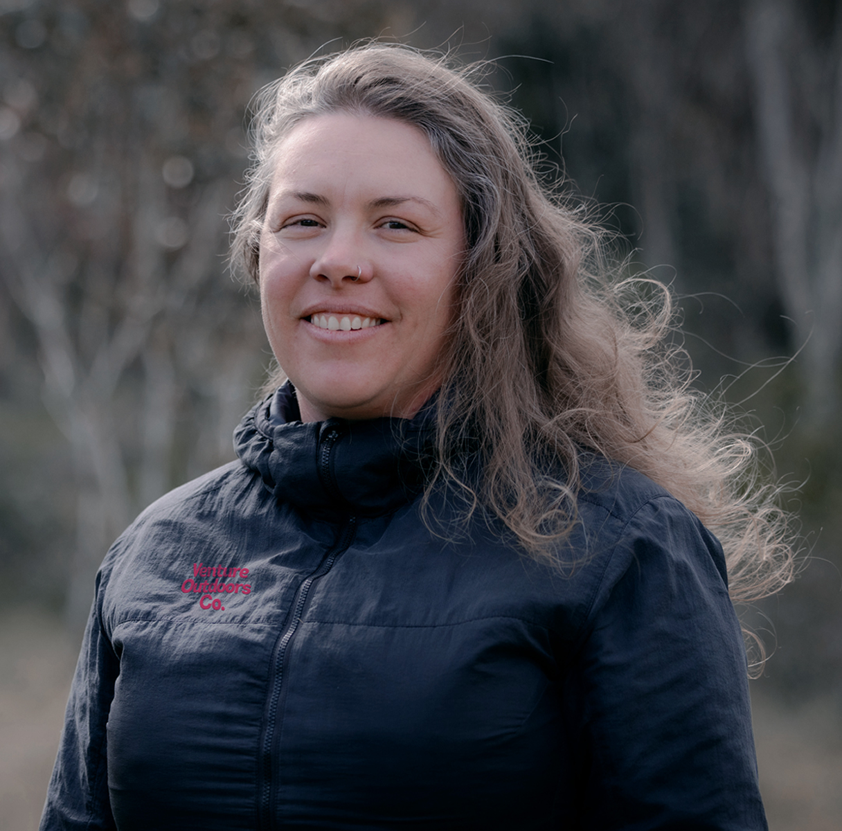 Portrait of Ashley Butler, Venture Outdoors Co. team member wearing uniform outdoors.