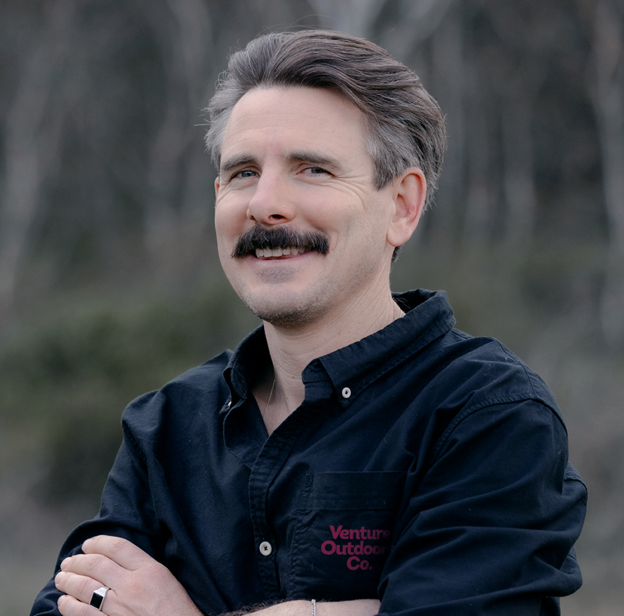 Portrait of Nate Brown, Venture Outdoors Co. team member wearing uniform outdoors.