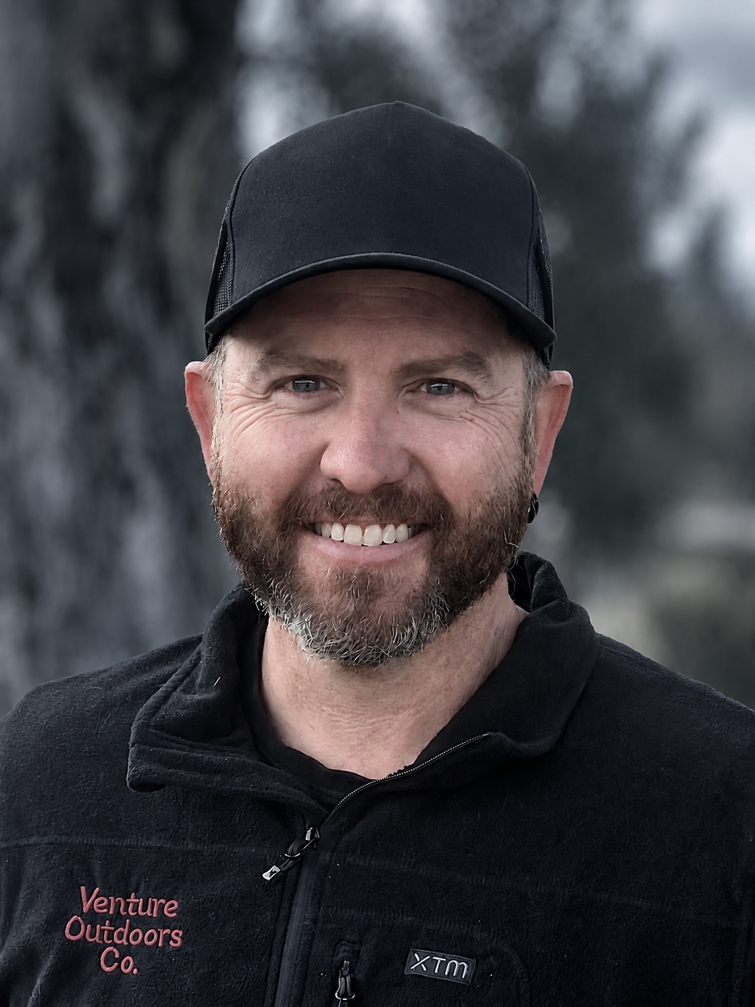 Portrait of John Graham, Venture Outdoors Co. team member wearing uniform outdoors.